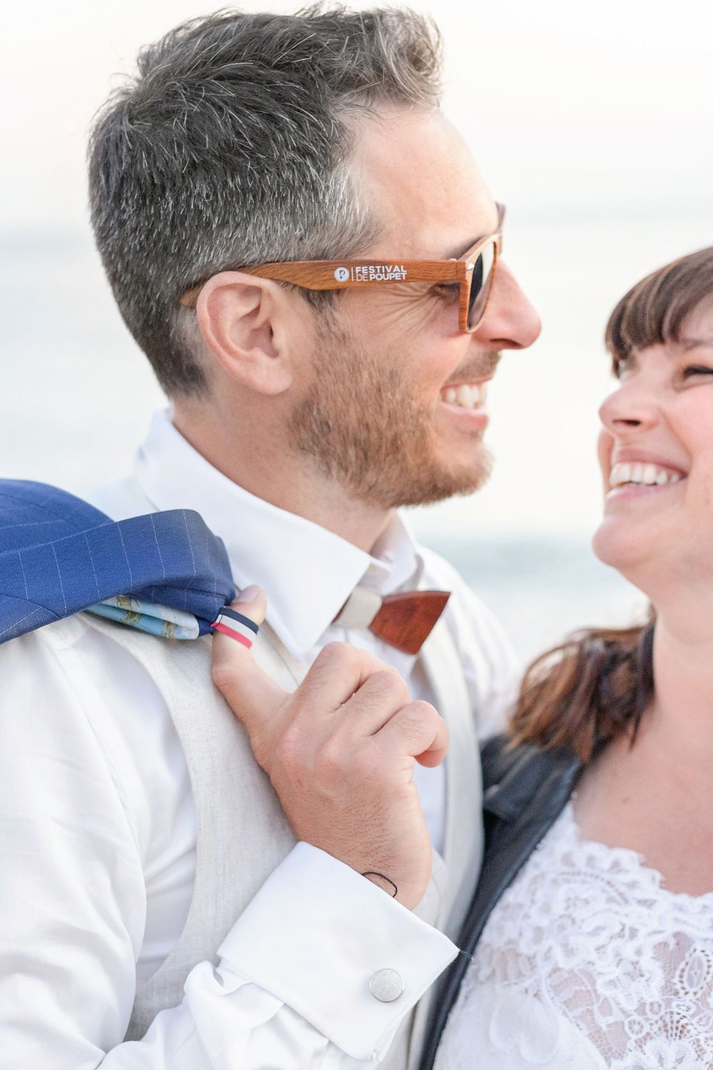 A candid moment of joy captured during a coastal wedding photoshoot.