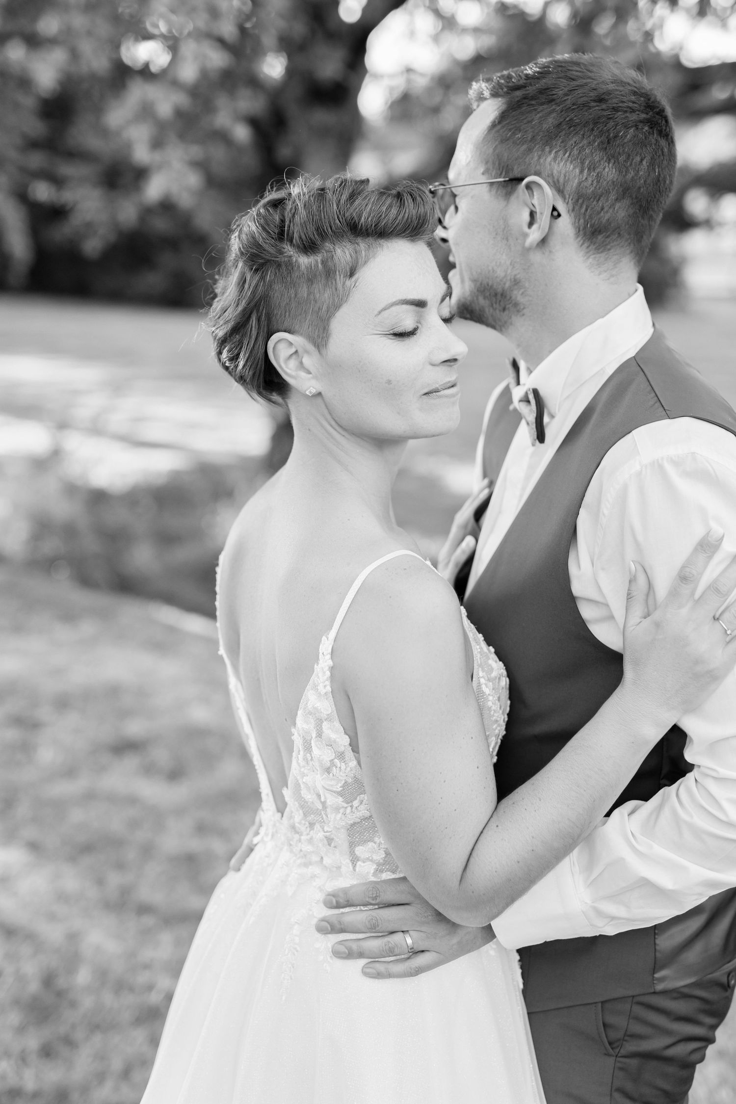 Classic black and white portrait of newlyweds sharing an intimate embrace.
