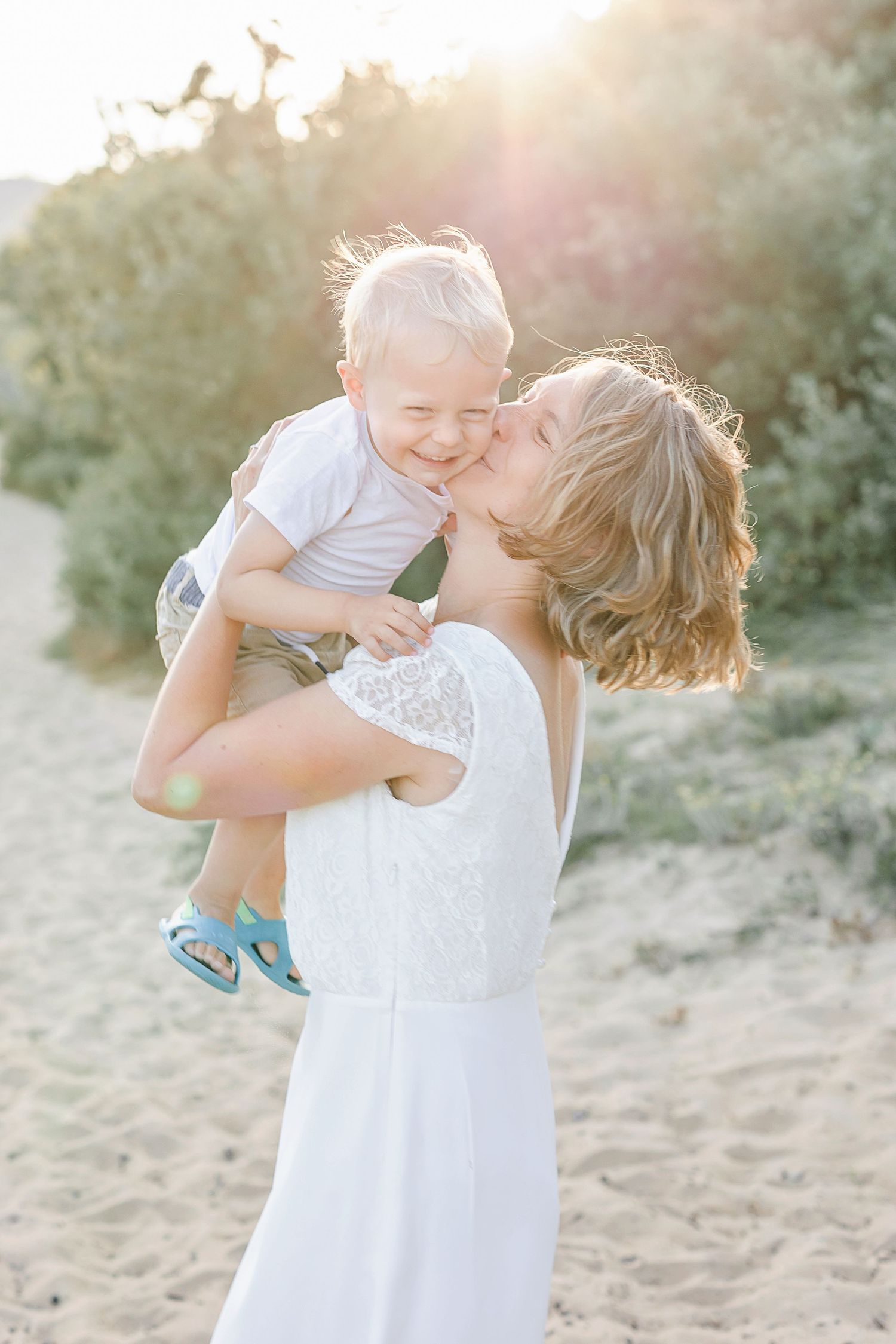 Candid family moments captured in soft golden light at sunset.