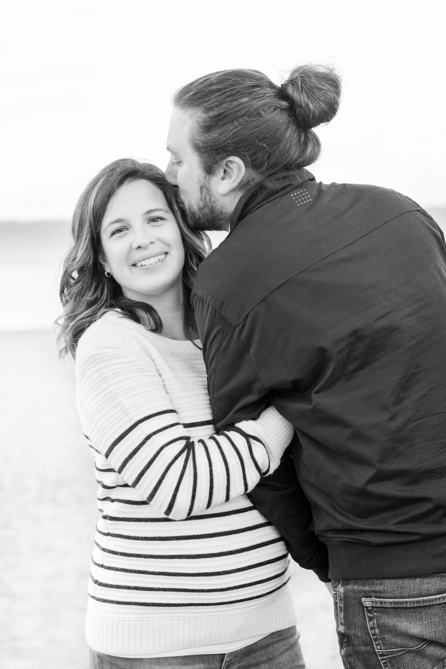 Sweet couple's photo sequence in black and white showing playful embraces.