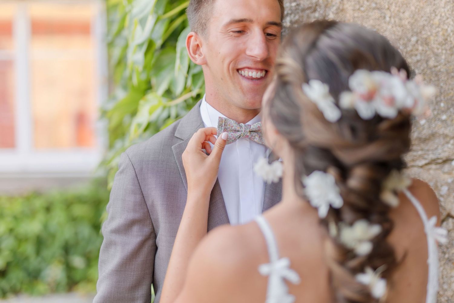 Close-up shot of wedding couple sharing a tender moment outdoors.