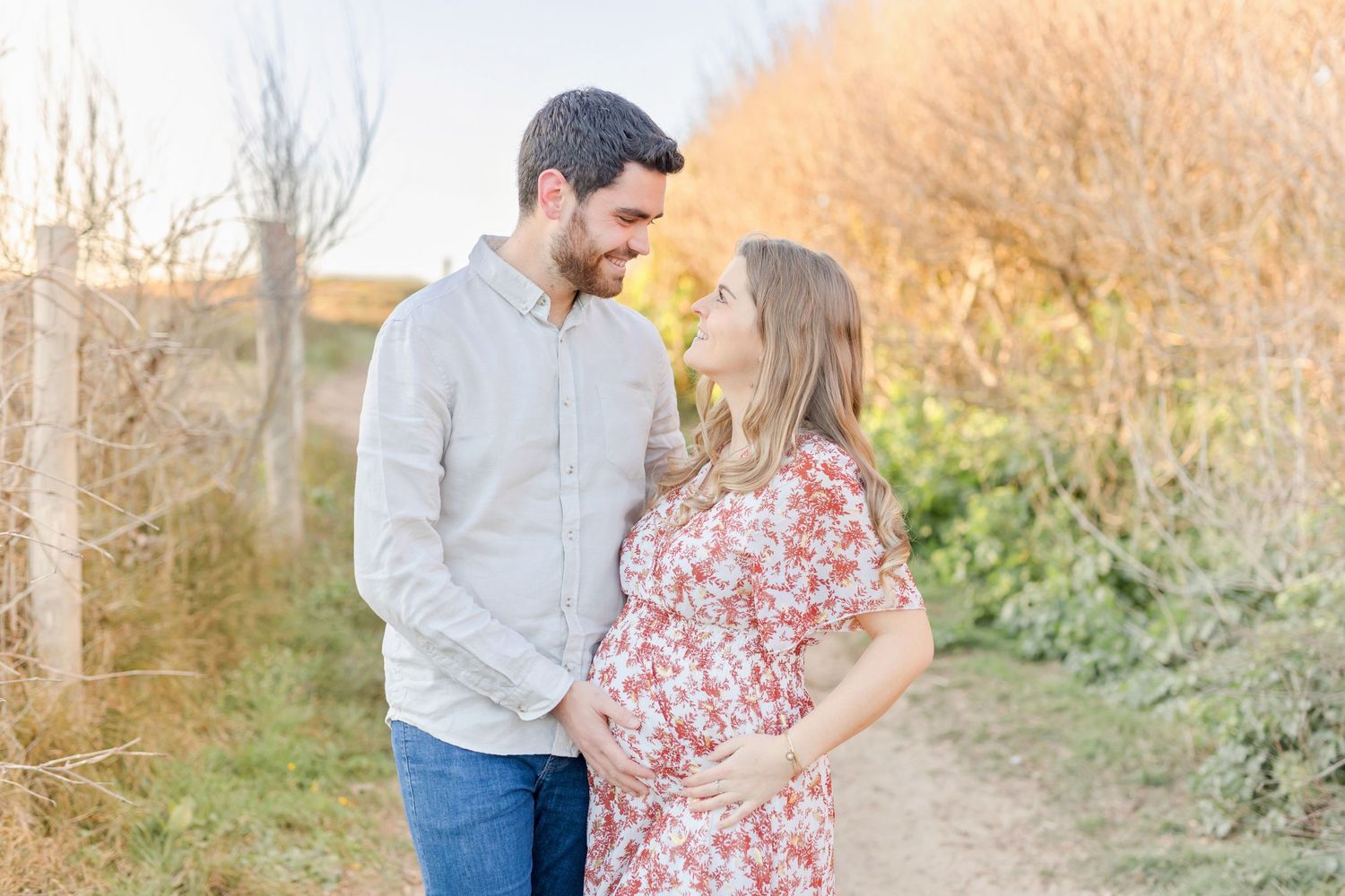 A romantic outdoor portrait session during sunset with natural golden lighting.