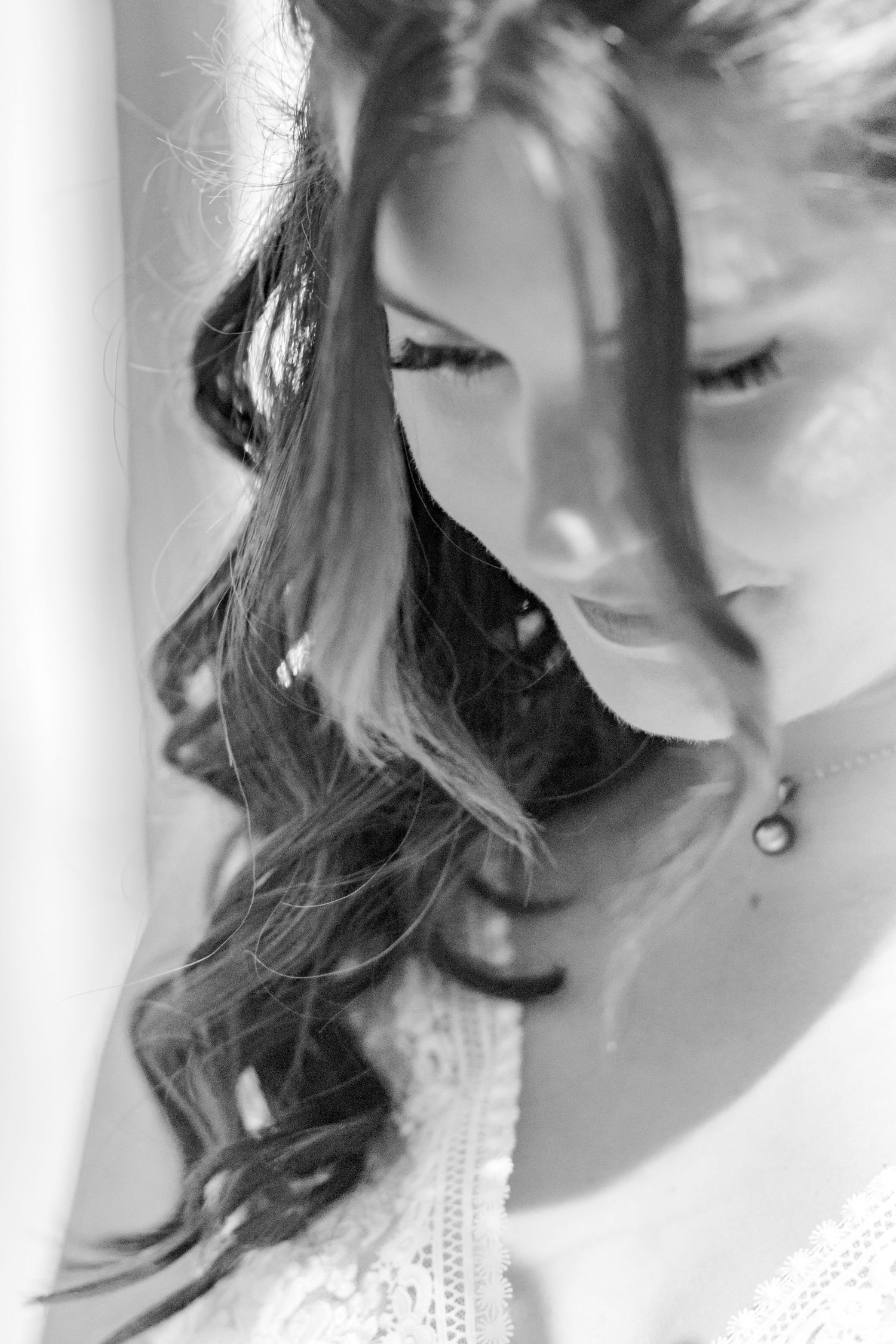 Artistic black and white profile shot highlighting elegant bridal styling and jewelry.