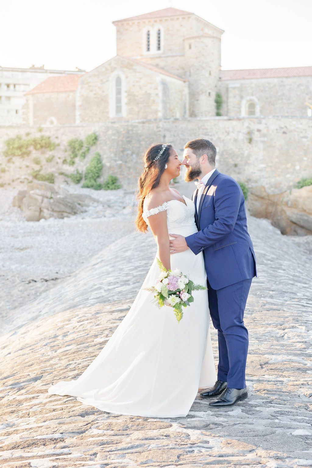 Romantic moments captured on historic stone pathway by Mediterranean villa.