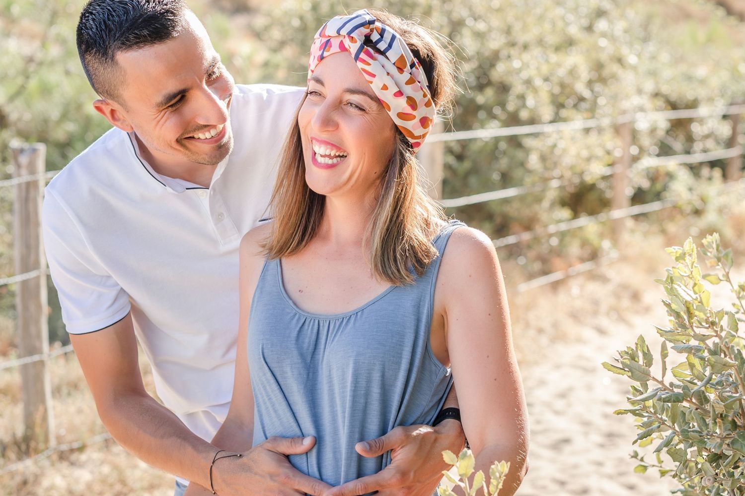 Romantic couples portraits taken on sandy dunes at golden hour.