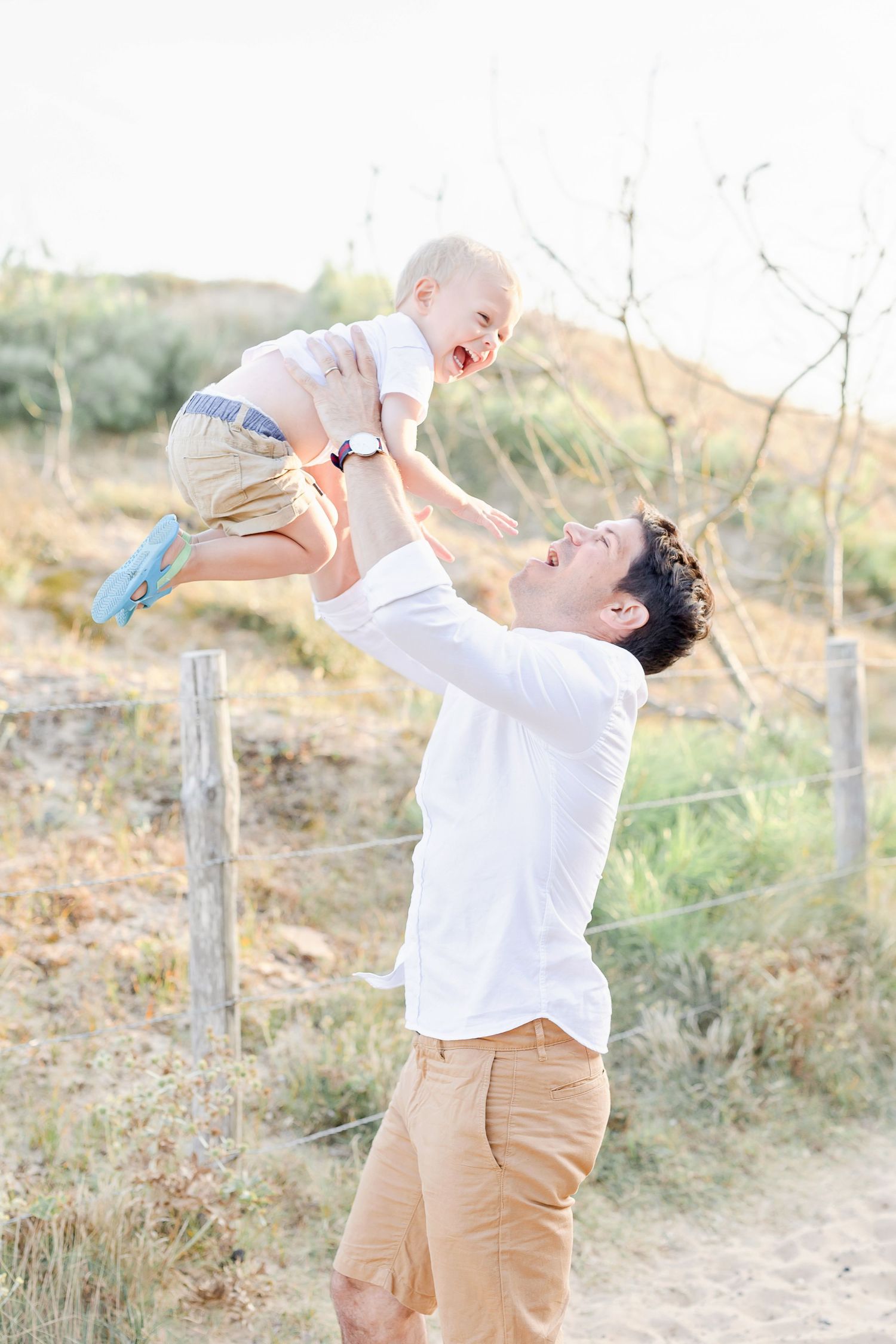 Loving playtime moments between parent and child in an outdoor setting.