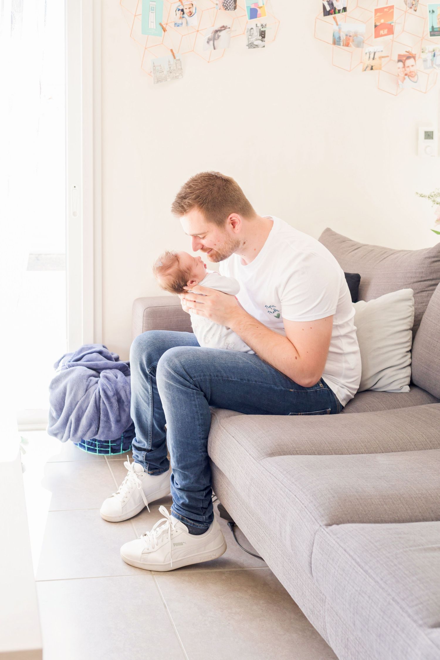 Side view of person lounging on gray sectional sofa in modern living room.