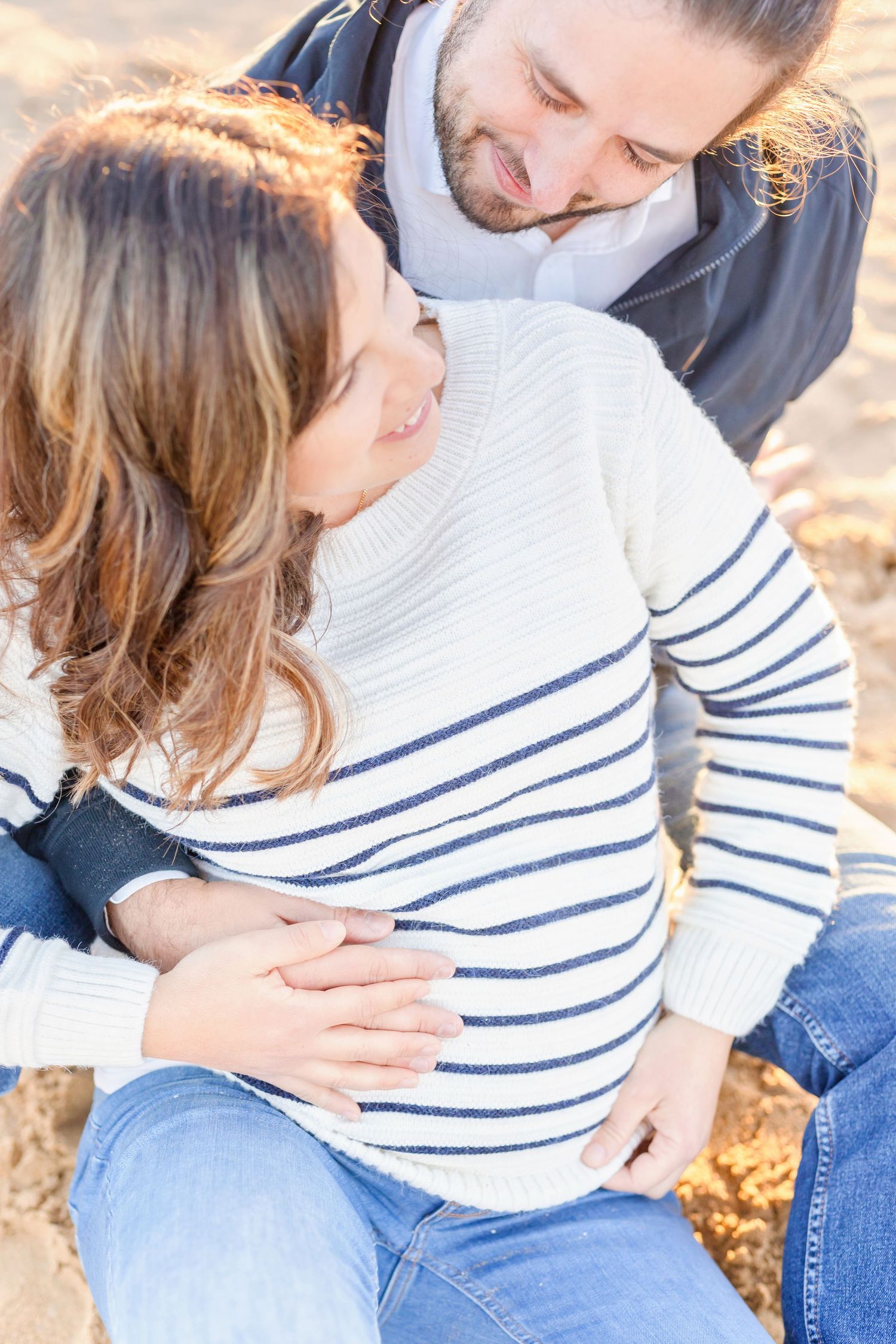 Romantic sunset photo series showing tender moments between a couple on a golden evening.
