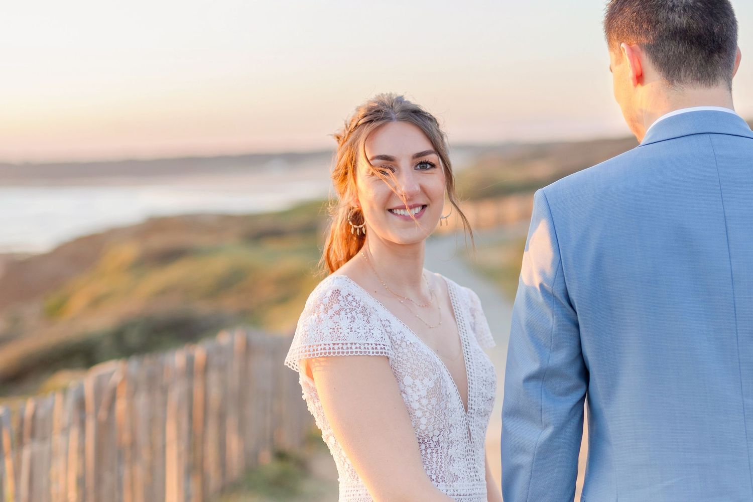 Golden hour wedding portrait of couple on California coast.