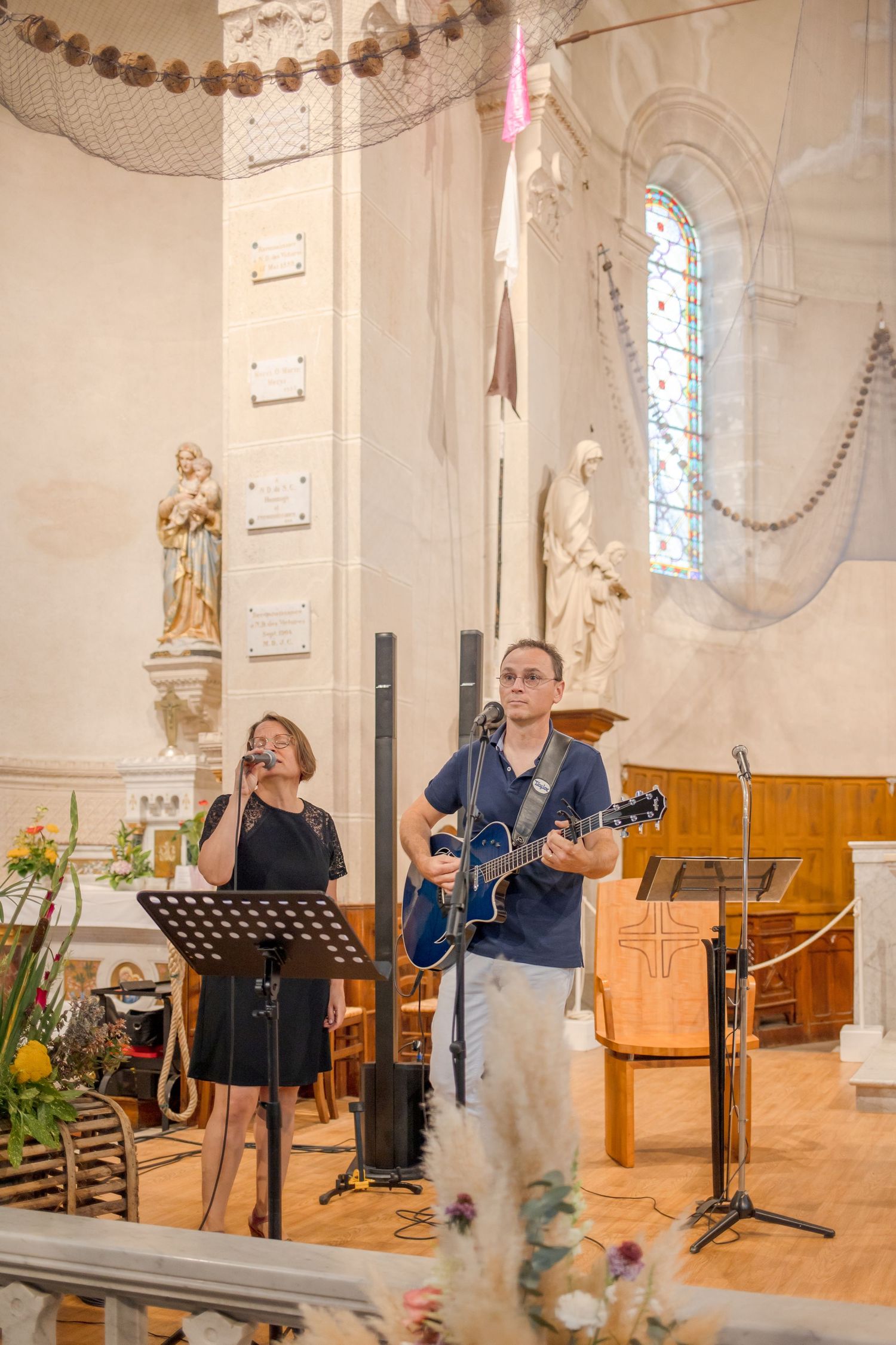 Musicians performing during a ceremony in a classic church interior.