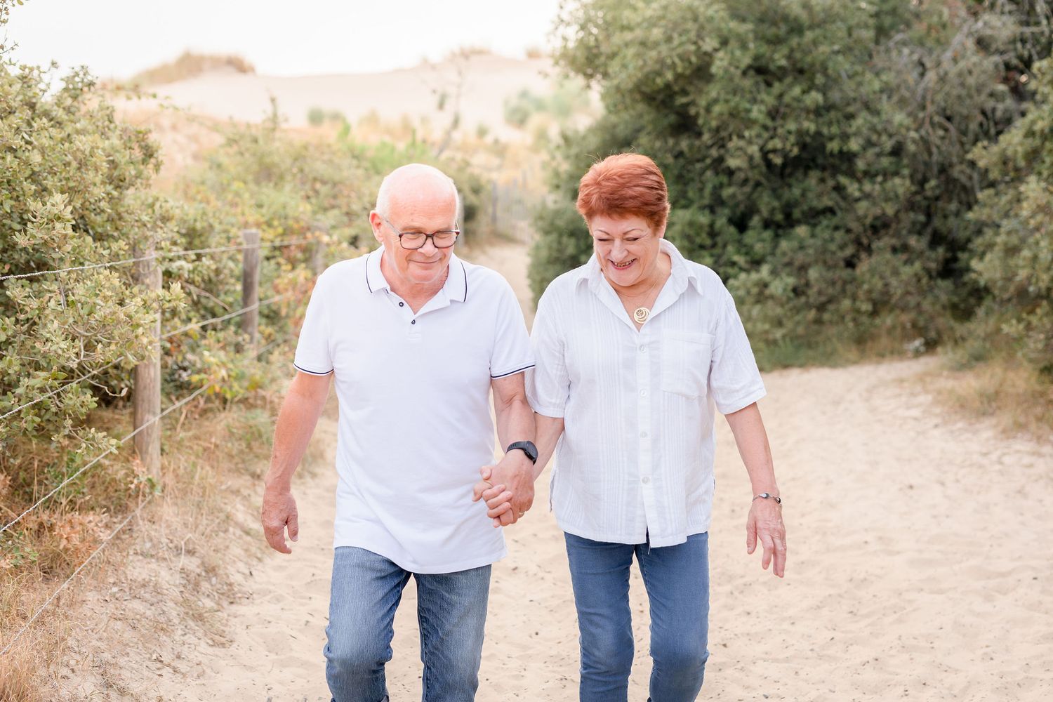 Casual family photos taken on a winding dirt path with desert vegetation and soft lighting.