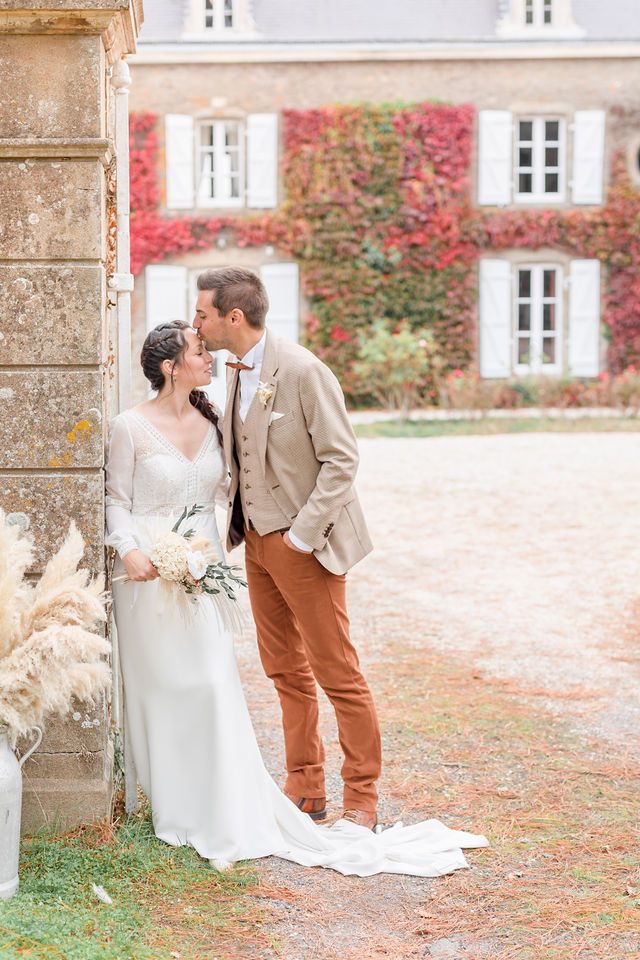 Romantic autumn wedding portraits with vintage styling and natural stone architecture.