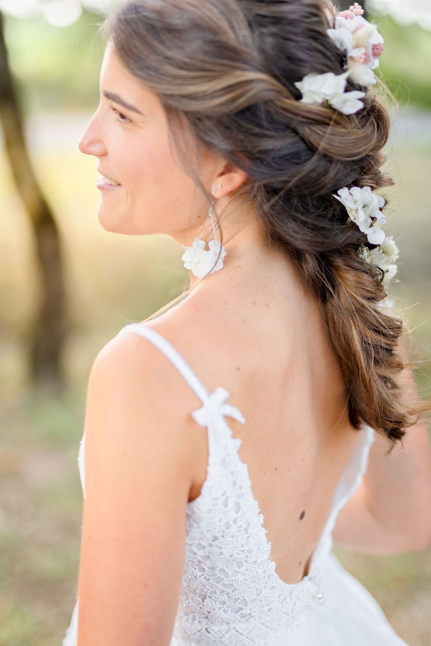 Elegant bridal hairstyle adorned with white flowers shown from multiple side angles.