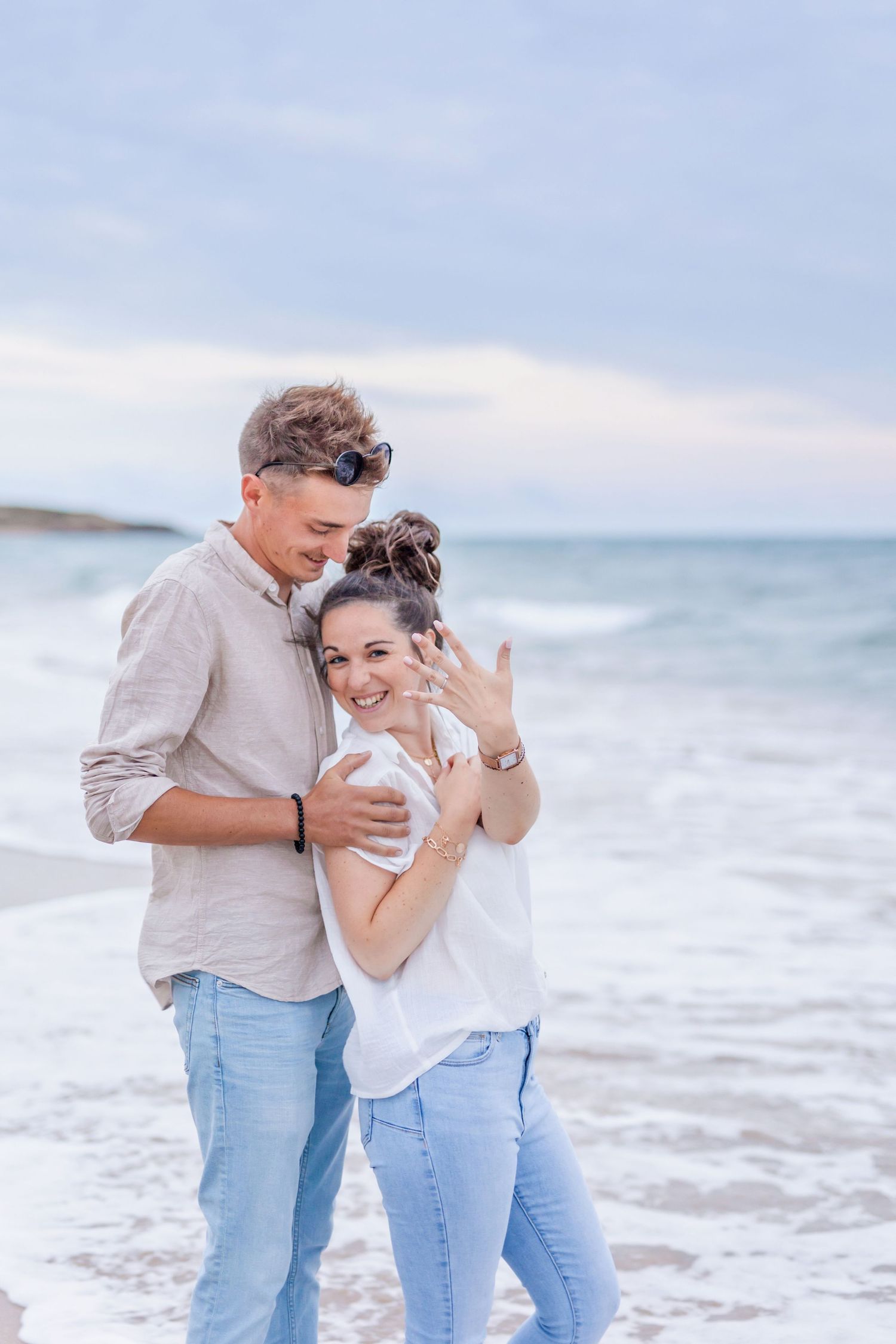 A joyful celebration on the beach as a couple shares an intimate moment.