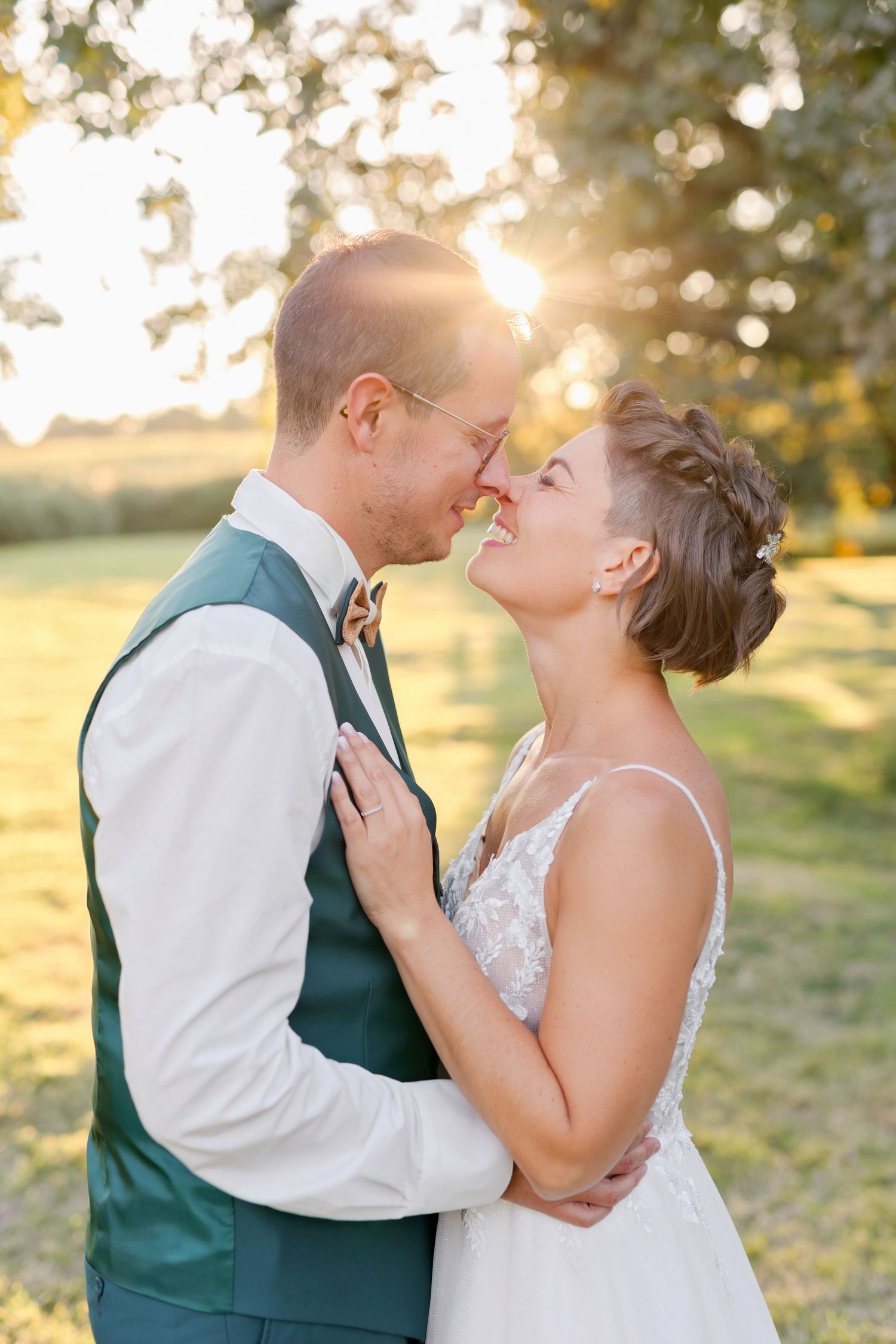 Sunset wedding portraits showing tender moments between newlyweds in a garden setting.