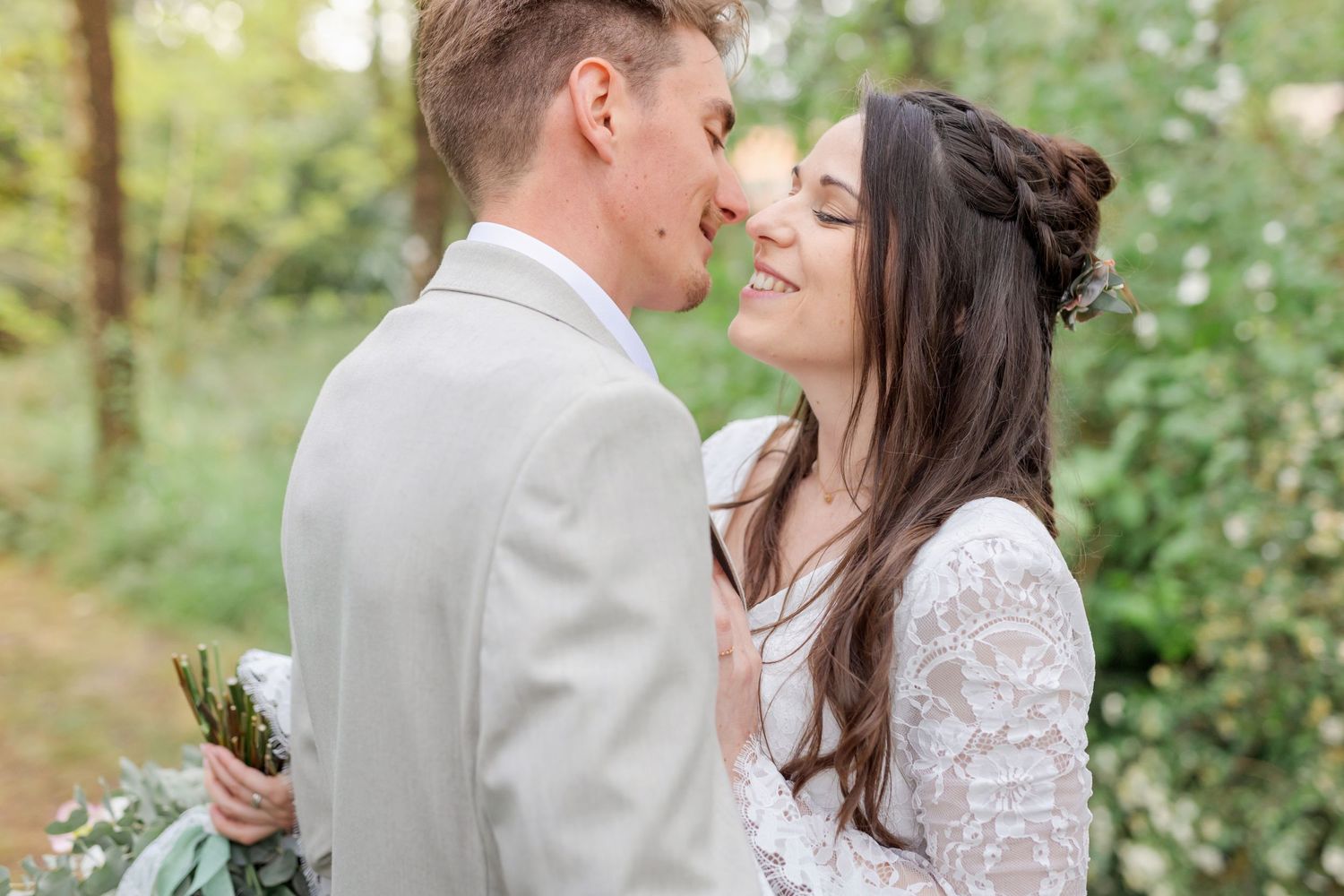 Wedding couple shares intimate moments during their forest photo session.