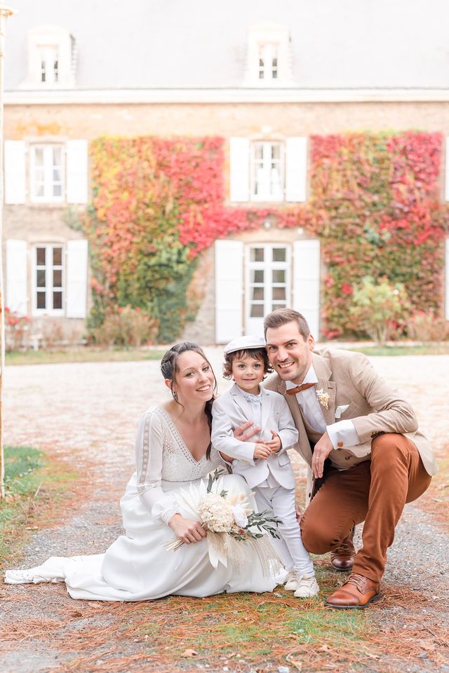 Intimate family portrait in front of an ivy-covered French chateau during autumn.