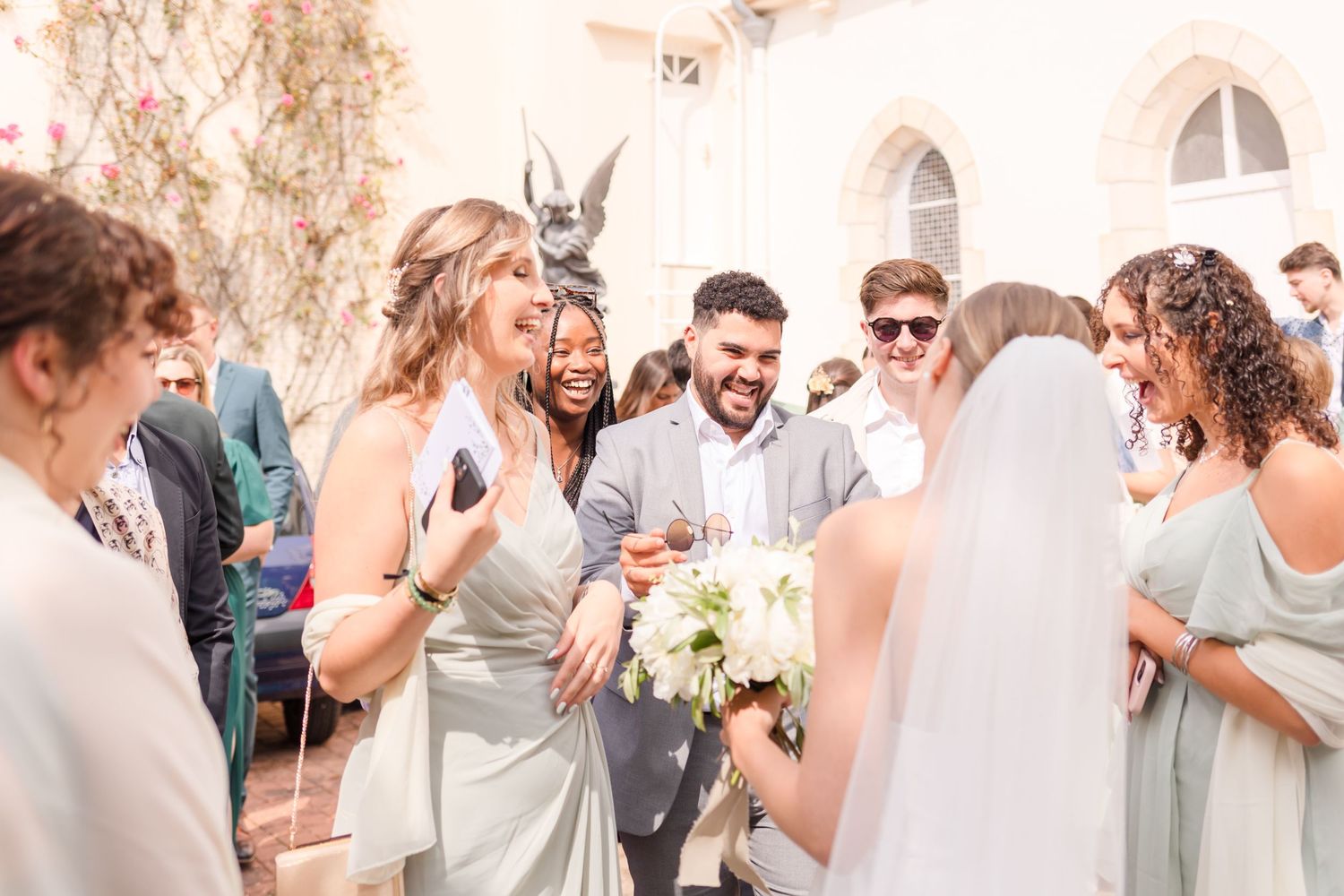 Wedding party members share excited reactions and laughter during outdoor celebrations.