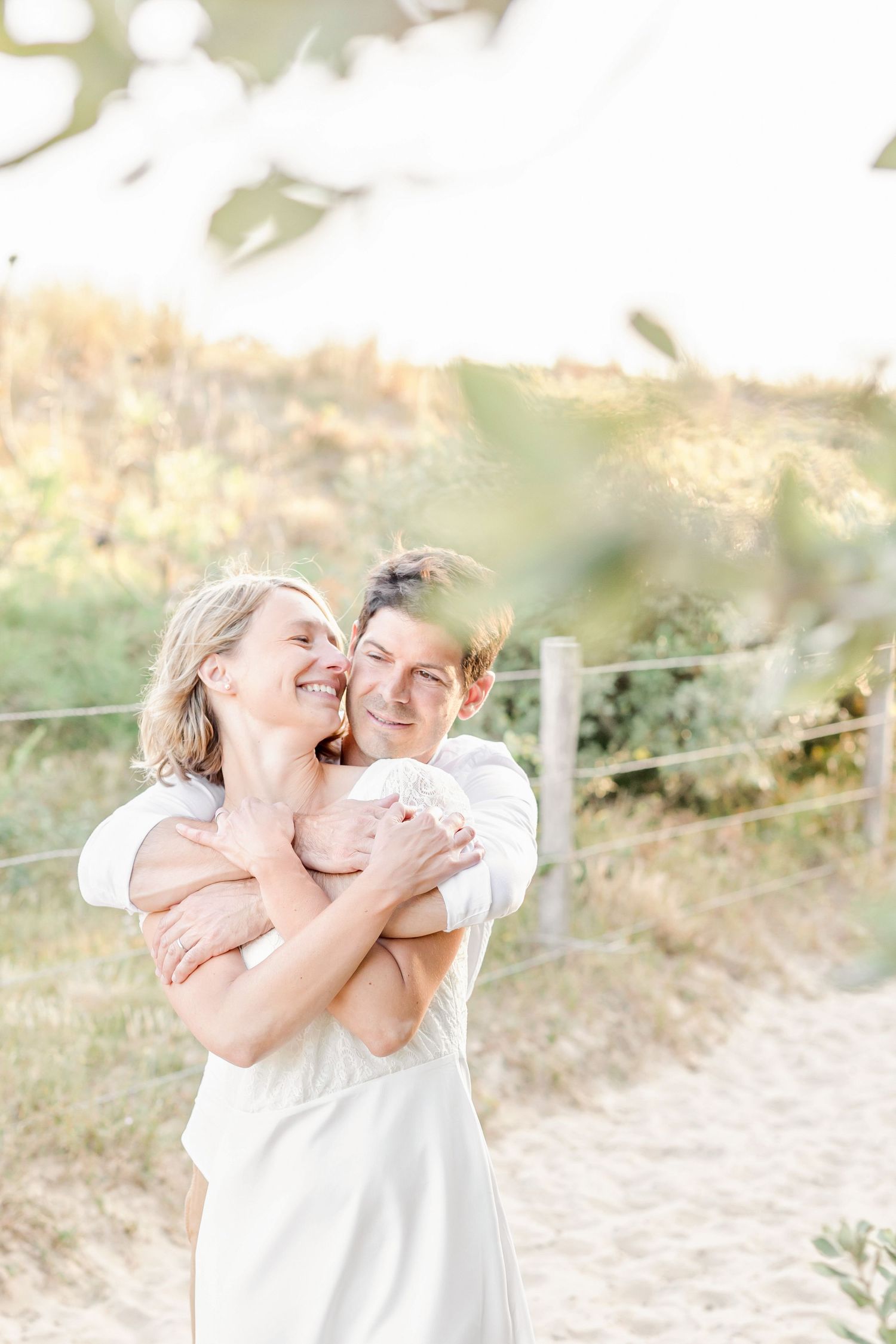 Heartwarming family embraces photographed in natural outdoor lighting.
