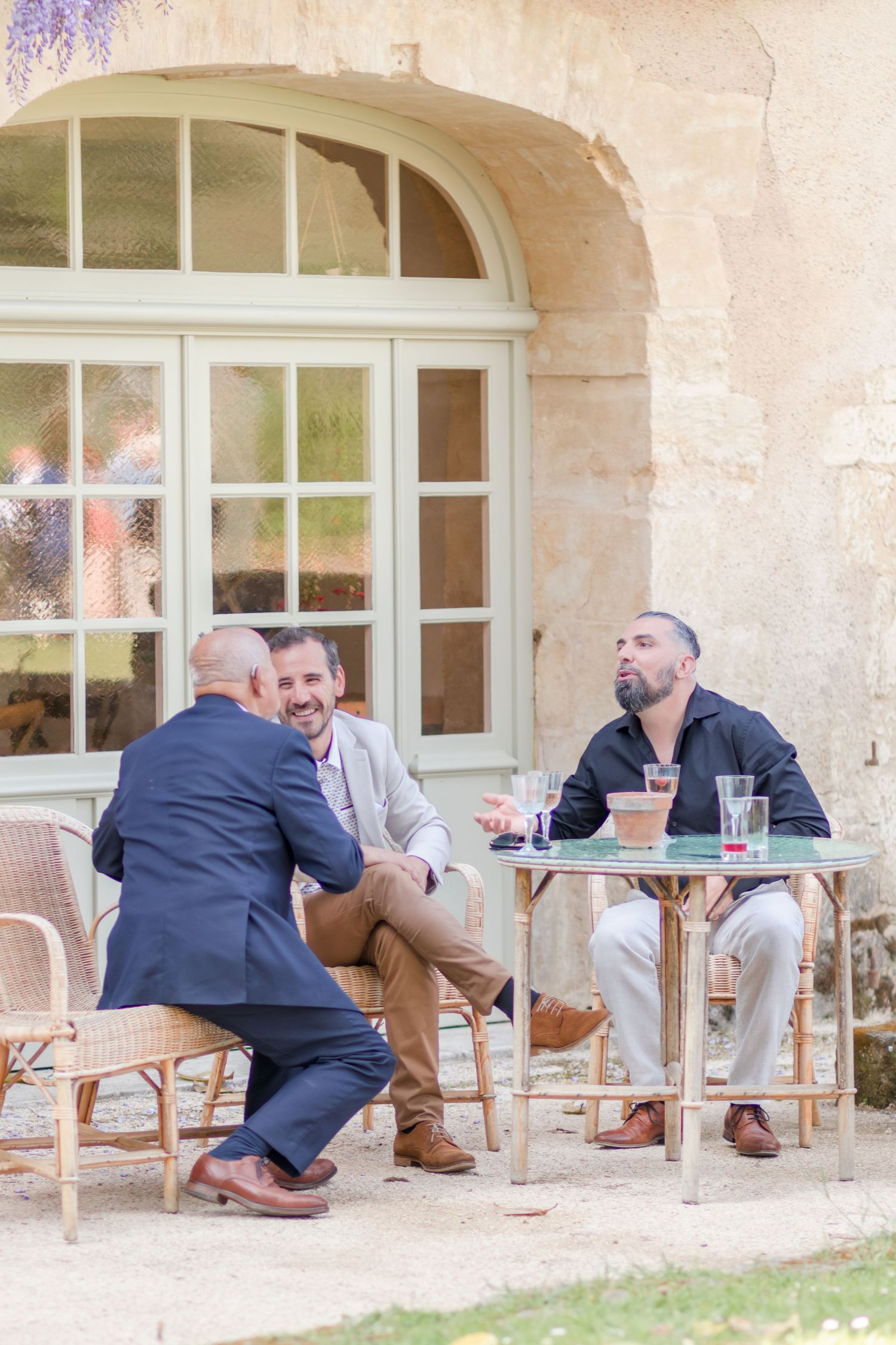 Group relaxing on outdoor patio furniture during a celebration.