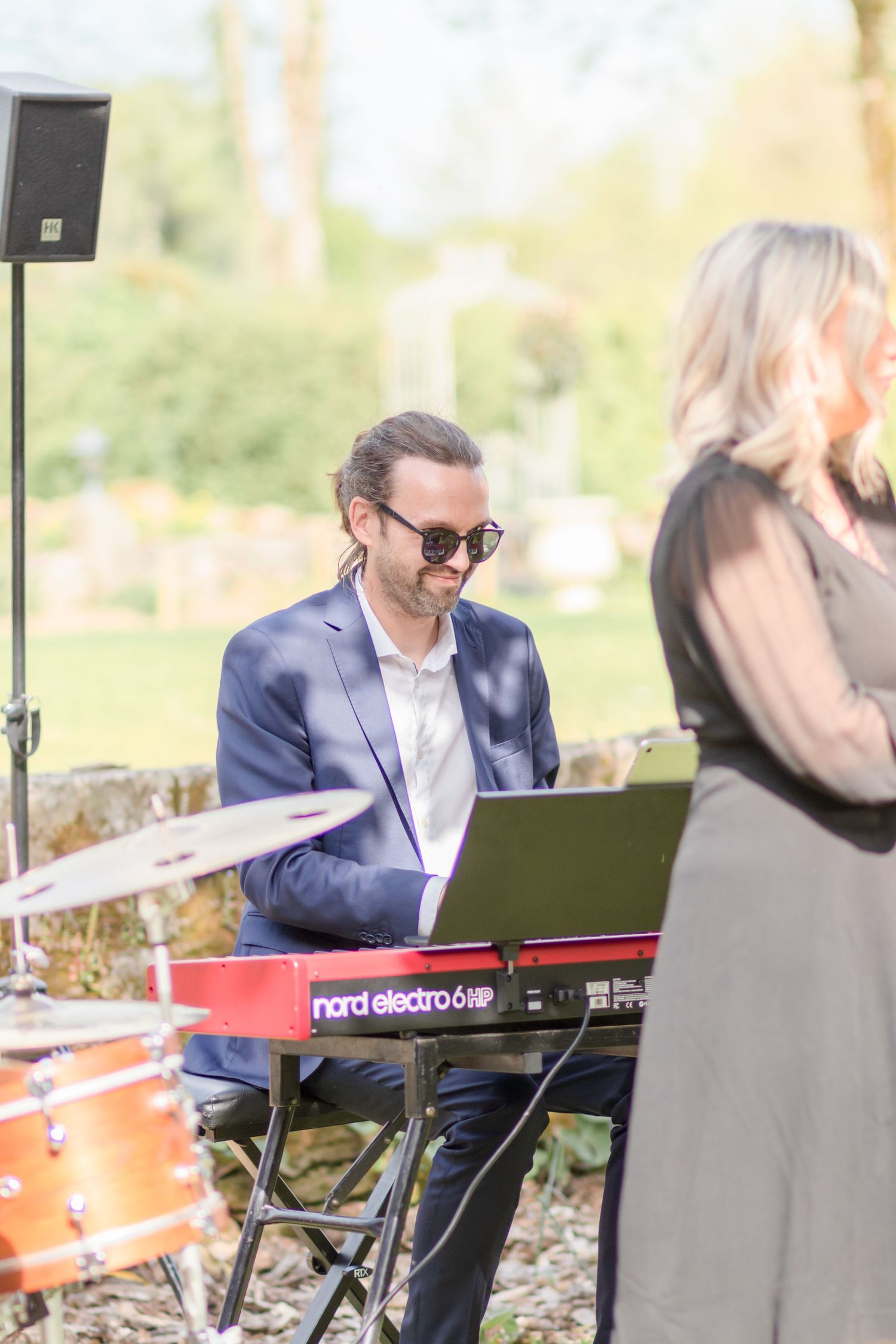Musical equipment and keyboards set up for an outdoor performance.
