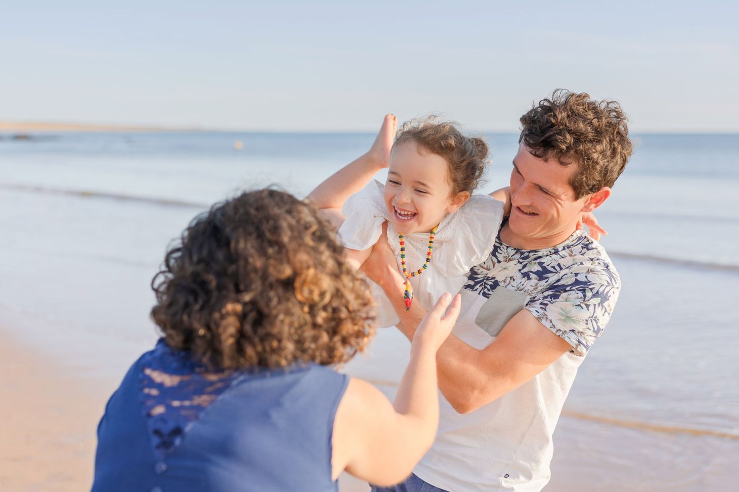 Sharing high fives and smiles during a fun beach day together.