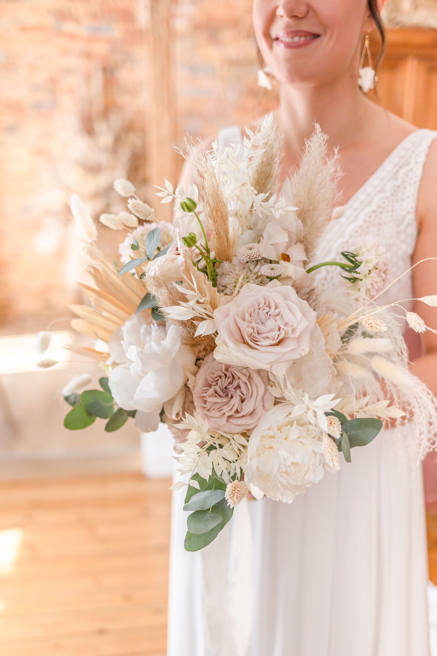 Elegant bridal bouquet featuring blush roses, white flowers, and eucalyptus greenery.