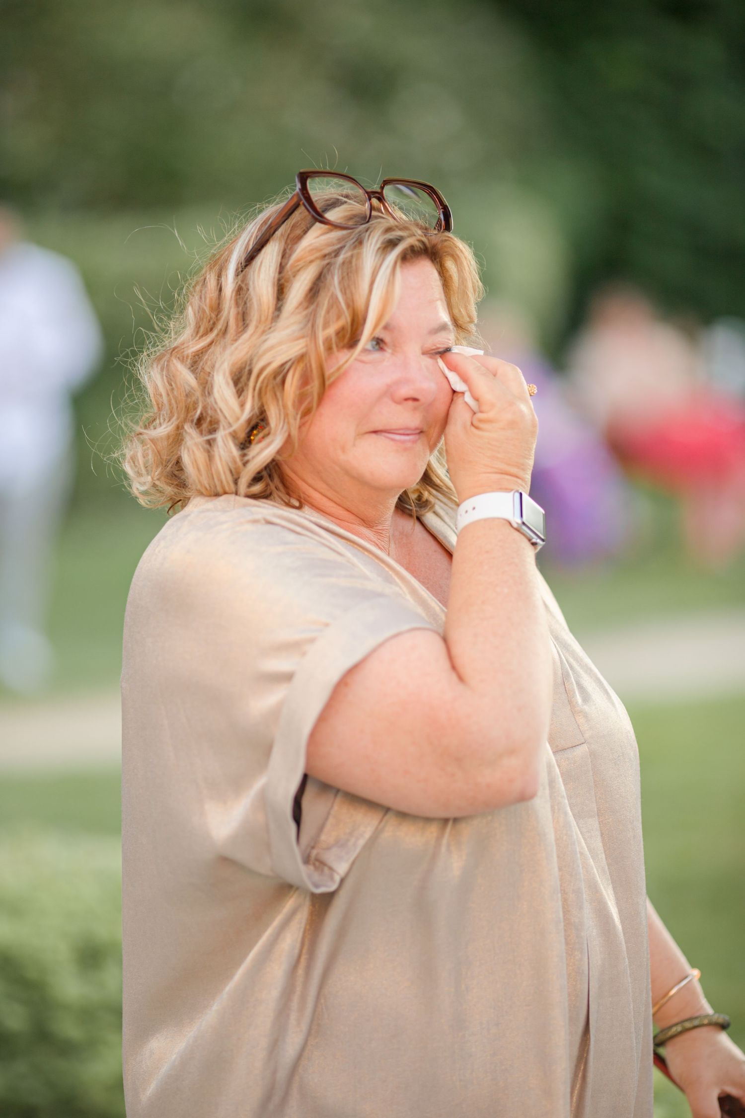 Emotional candid moment captured during outdoor wedding celebration.