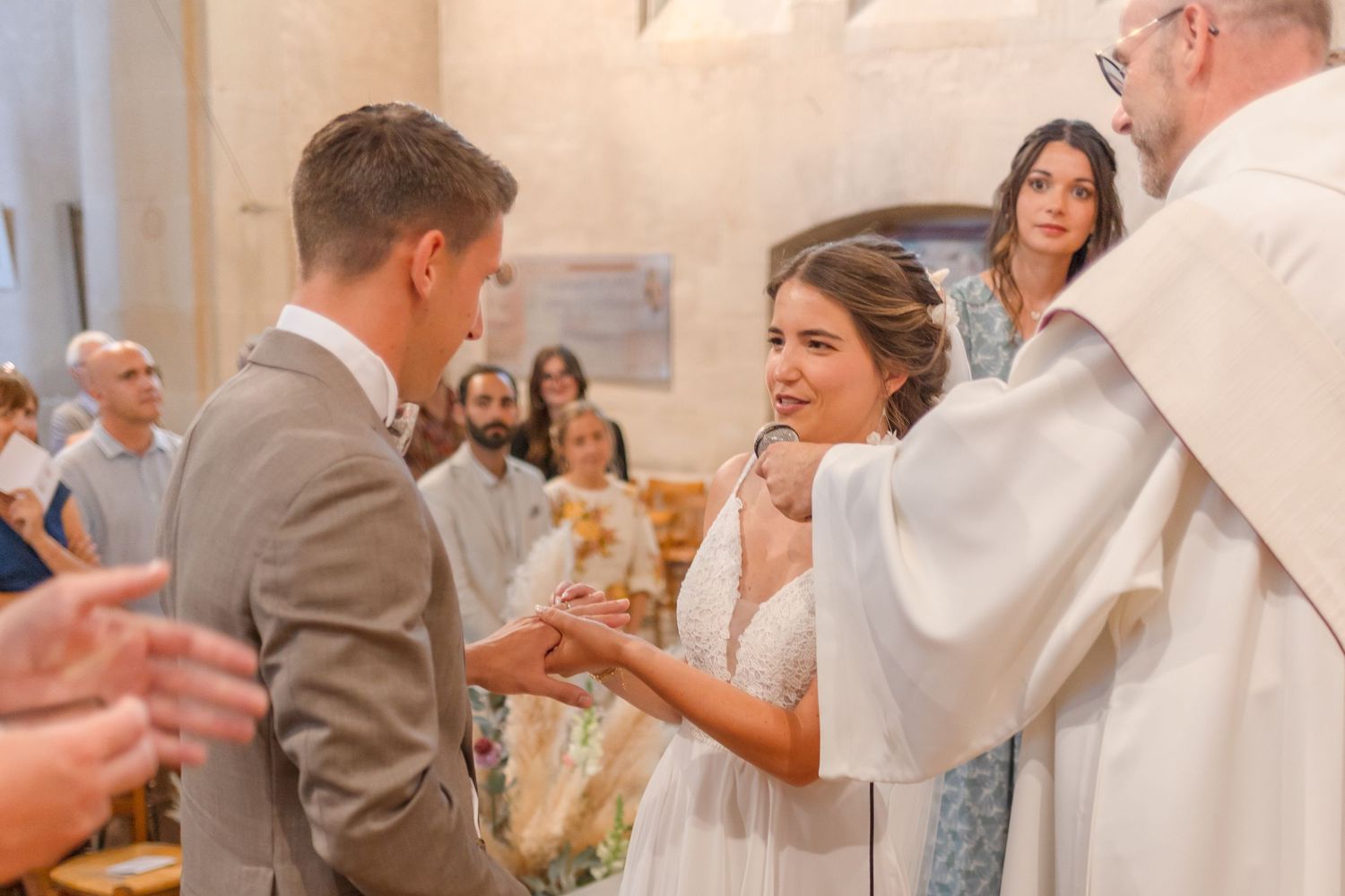 Wedding ceremony detail shot showing exchange of rings in church.