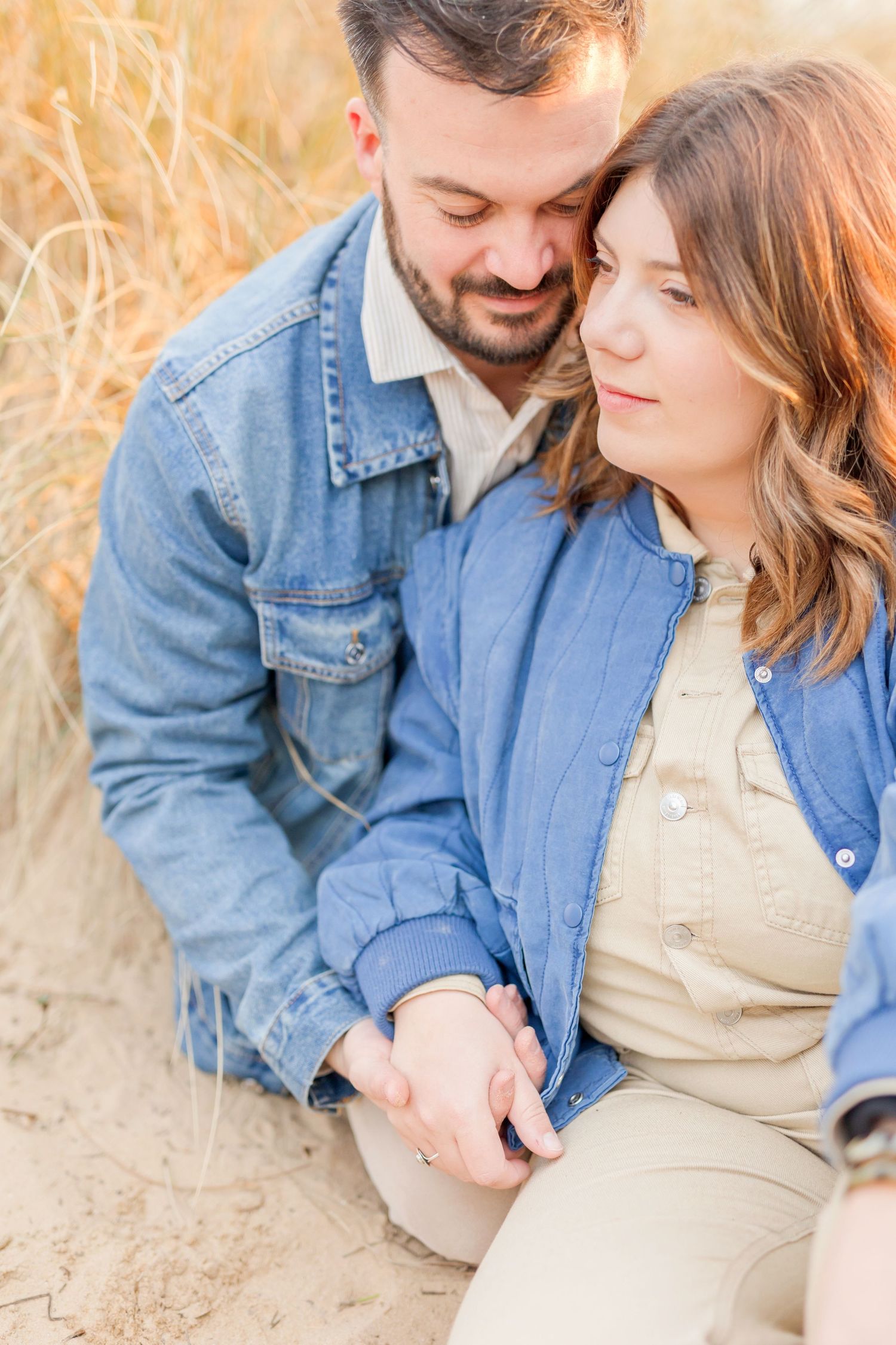 Close-up shots of couple sharing tender moments on beach in matching denim.