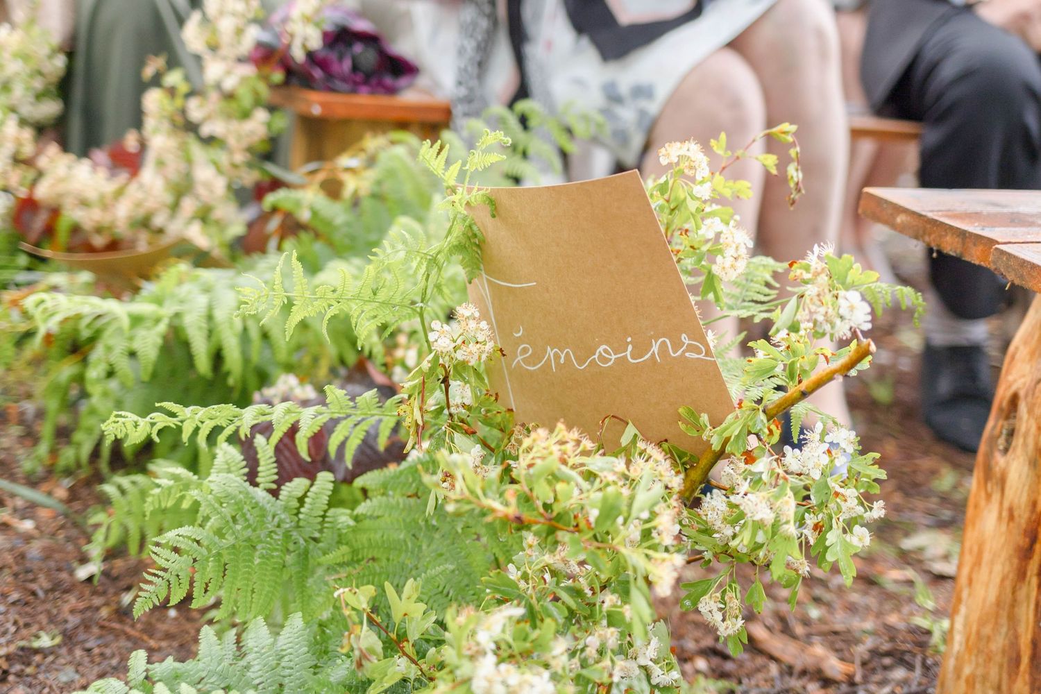 Delicate white and green floral arrangements line the outdoor seating area.