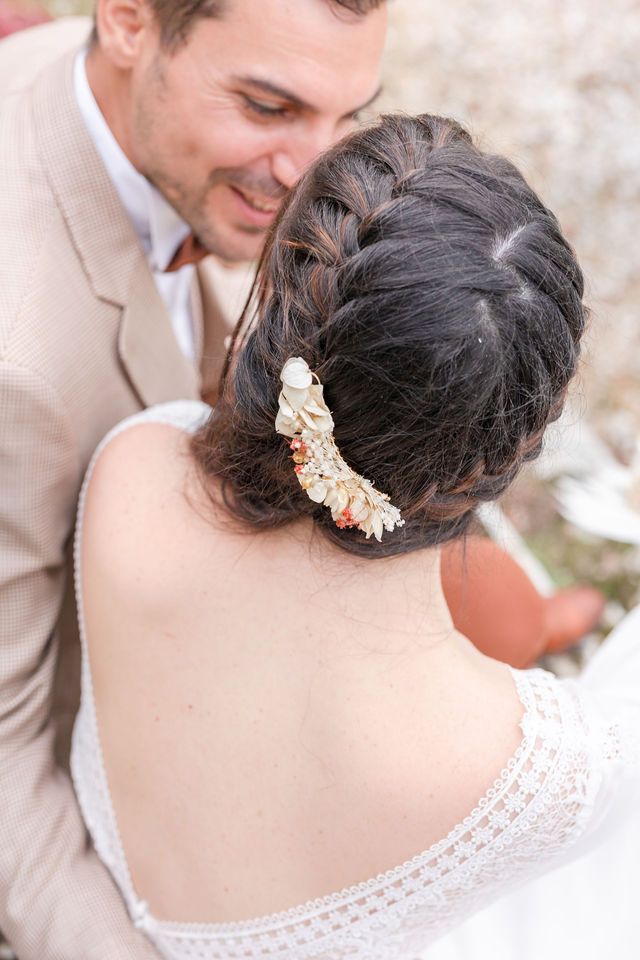 Close-up of an elegant bridal hairstyle with floral hair accessories.