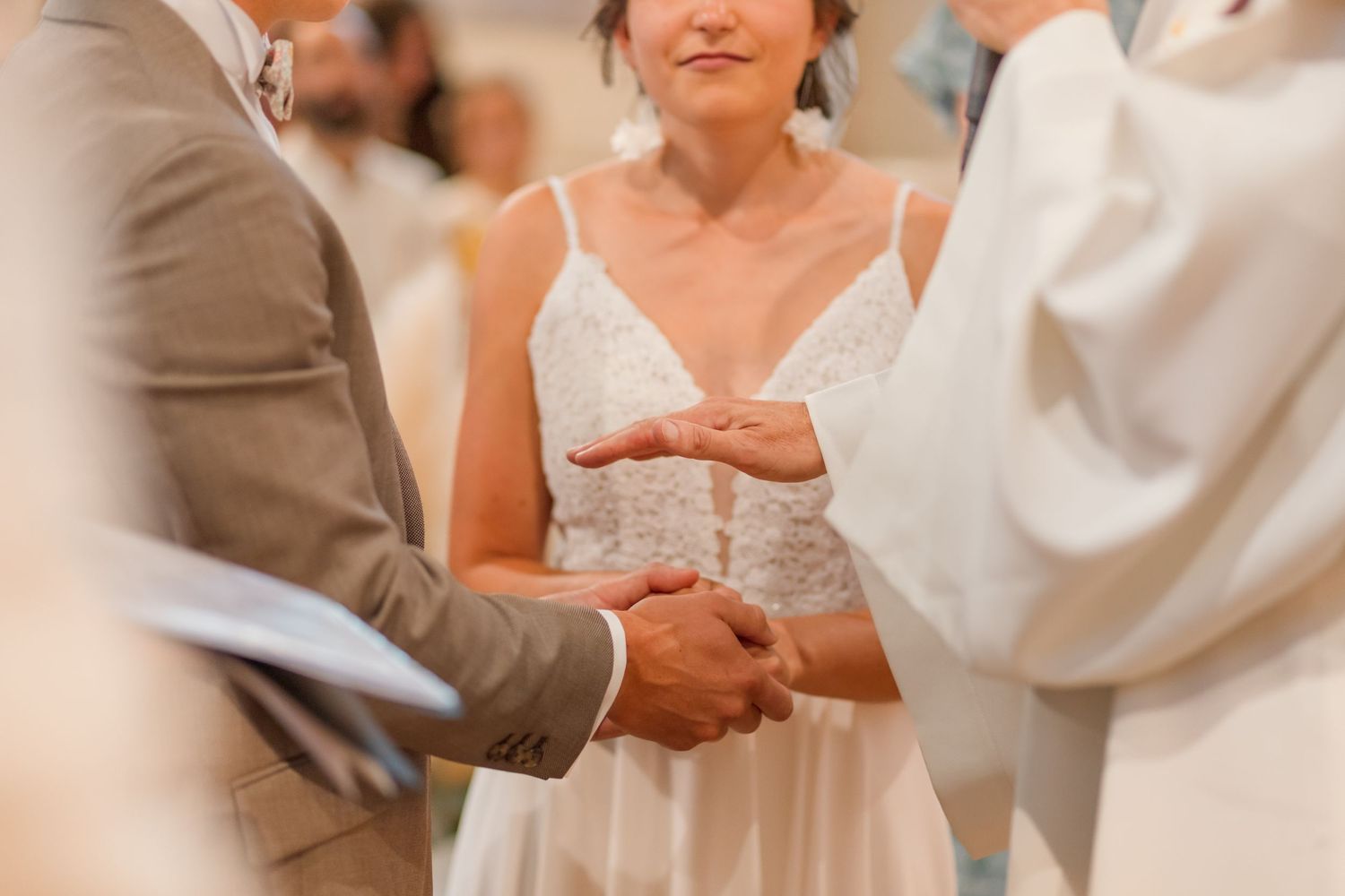 Hands exchanging rings during intimate wedding ceremony.