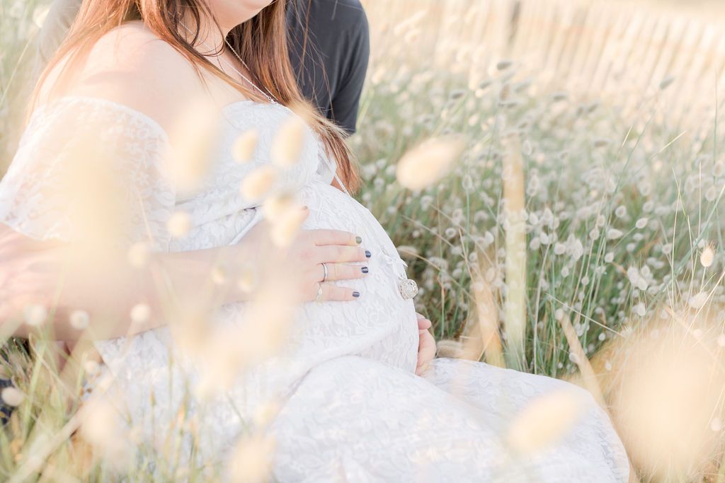 A tender embrace captured in a sun-drenched field of flowers during golden hour.