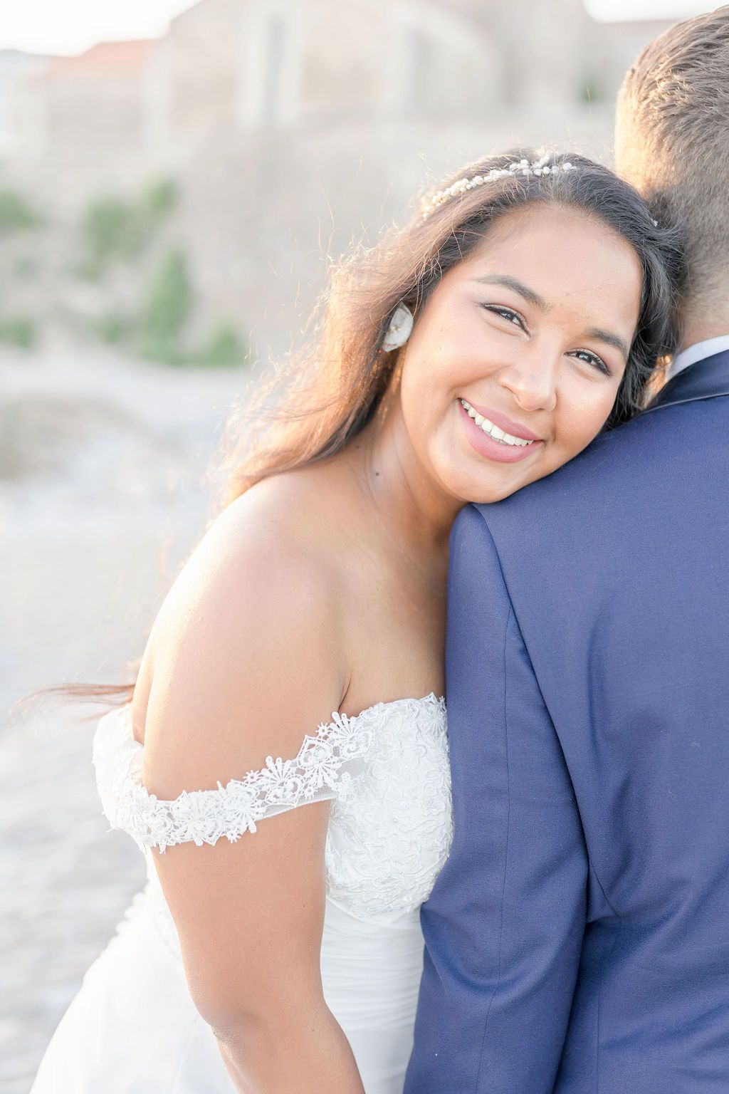 Intimate wedding portrait capturing tender moments in soft natural lighting.
