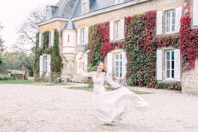 Elegant French chateau with ivy-covered walls and a flowing white dress in motion.