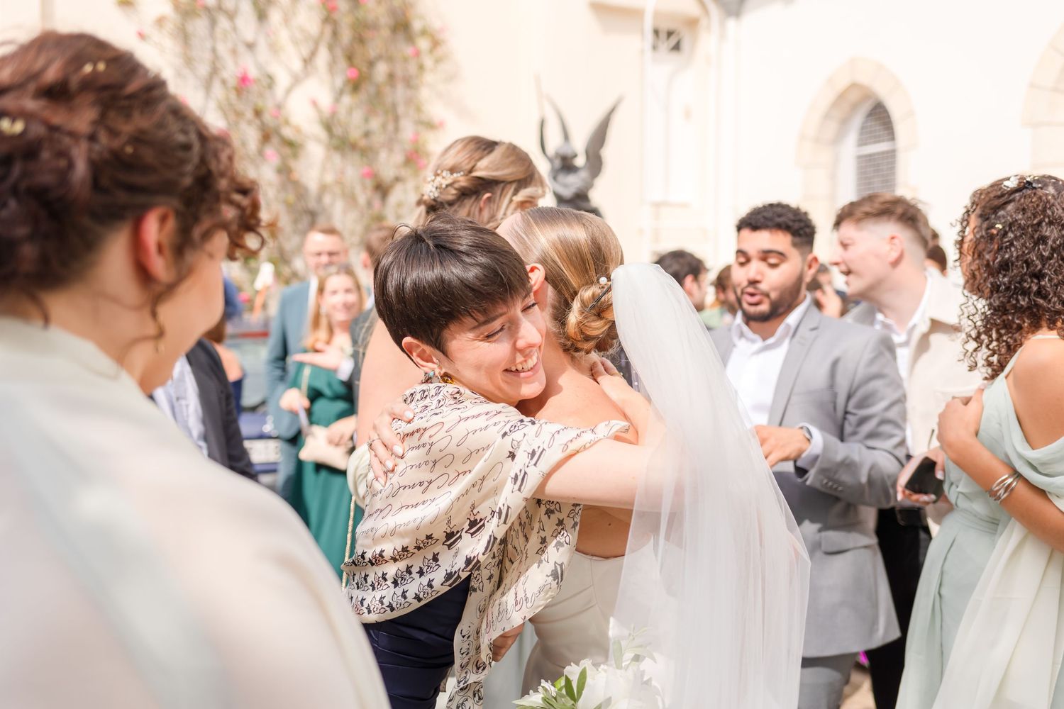 Wedding guests embrace and celebrate with joyful emotions during the reception.
