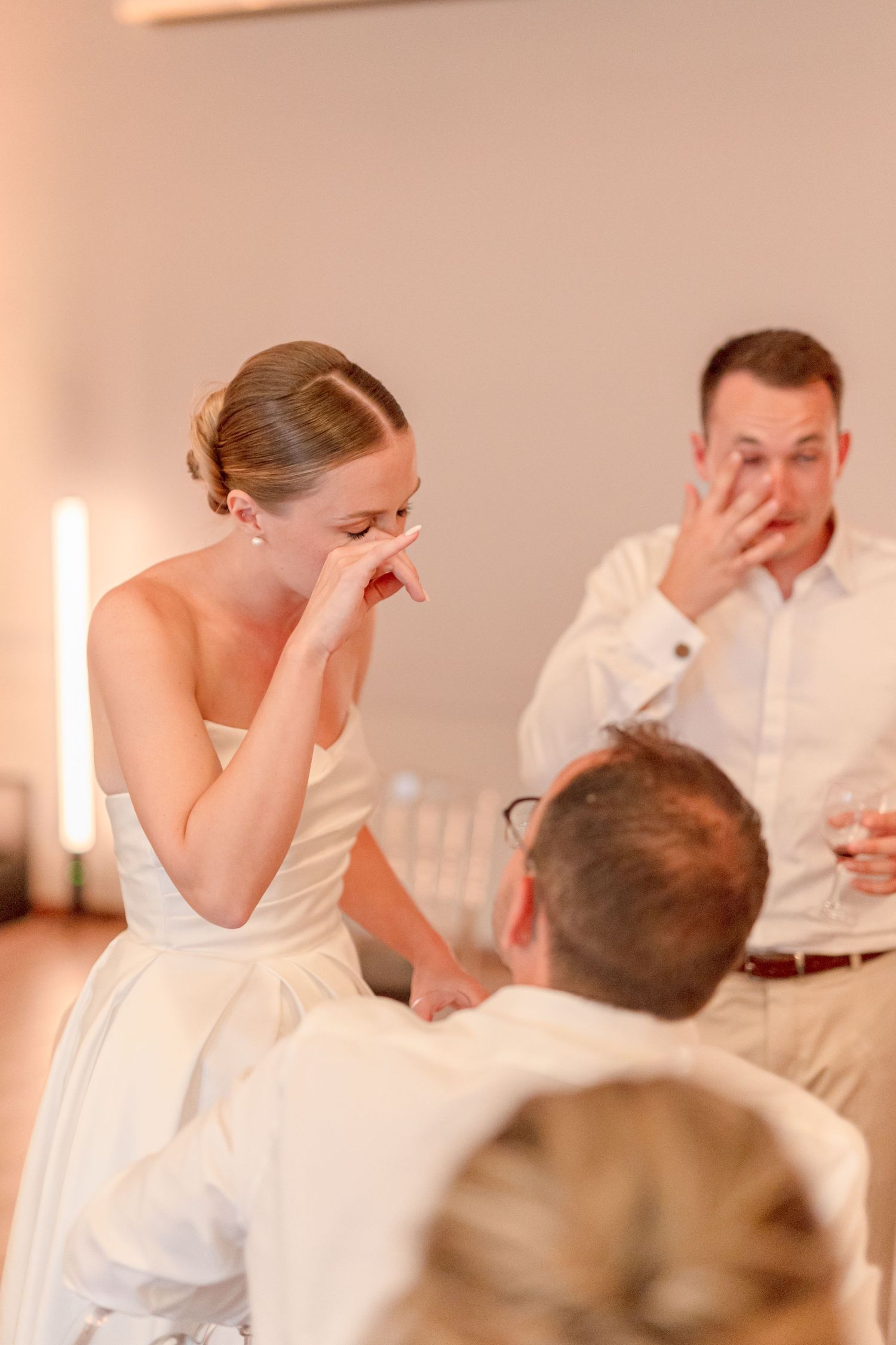 Emotional reaction captured during wedding reception speeches.