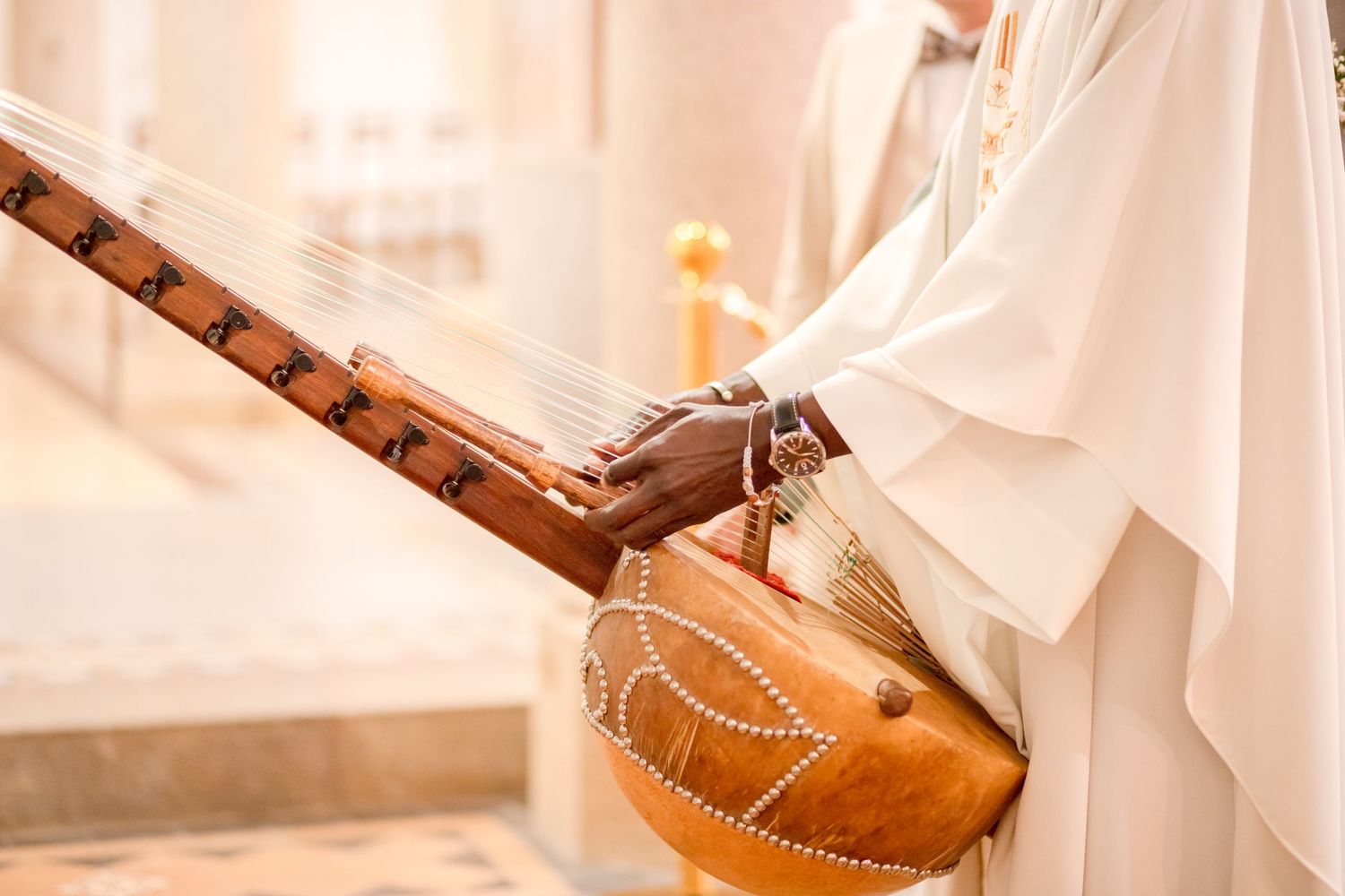 Traditional brown leather guitar case with intricate details shown during church ceremony.