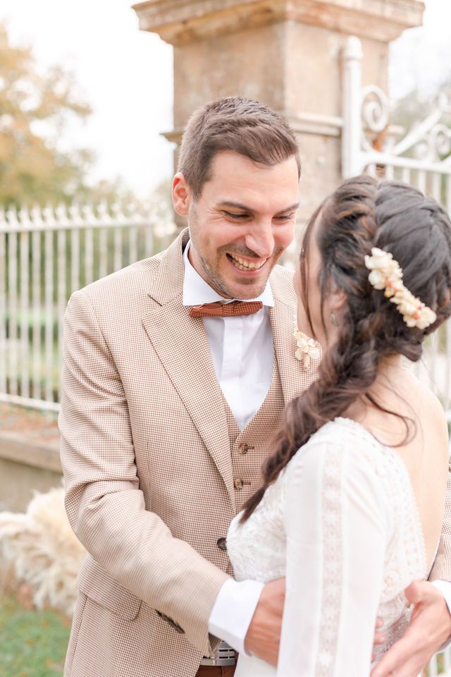Candid moments of joy shared between newlyweds in front of a historic stone building.