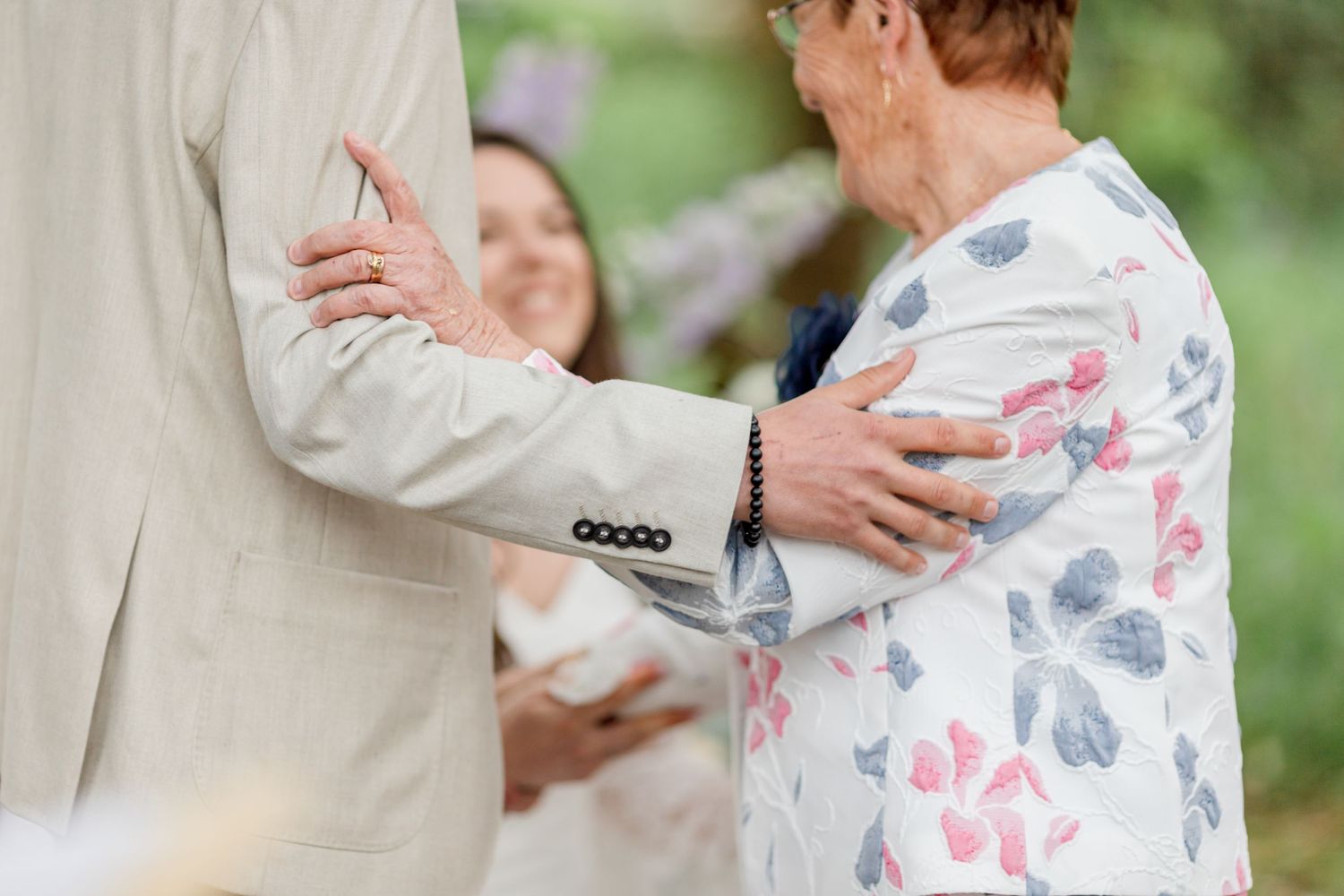 Intimate moment captured during outdoor celebration with floral decor.