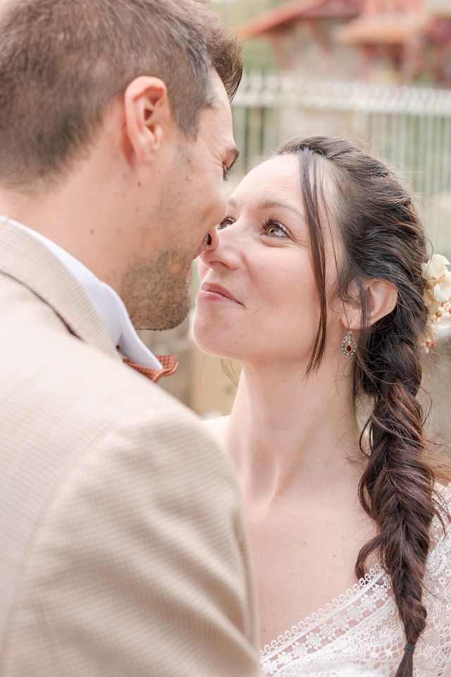 Intimate closeup of newlyweds sharing tender moments during their autumn wedding photoshoot.