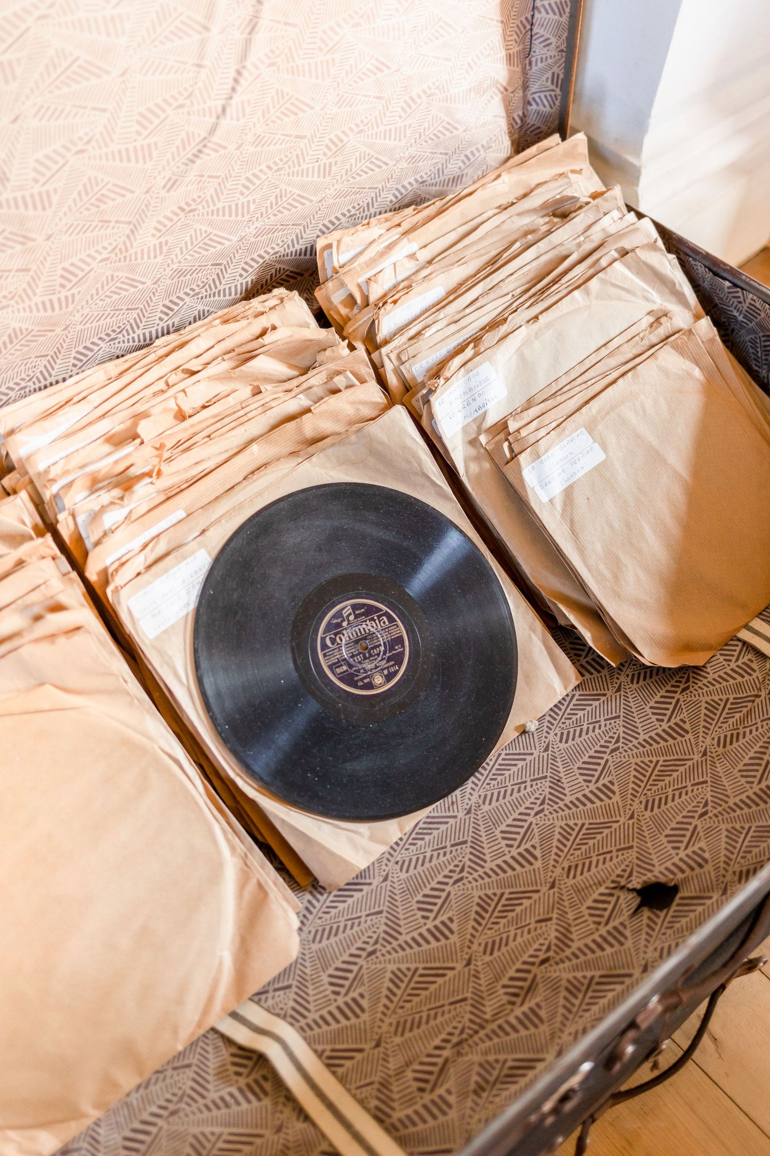 Vintage vinyl records displayed on a textured bedspread.