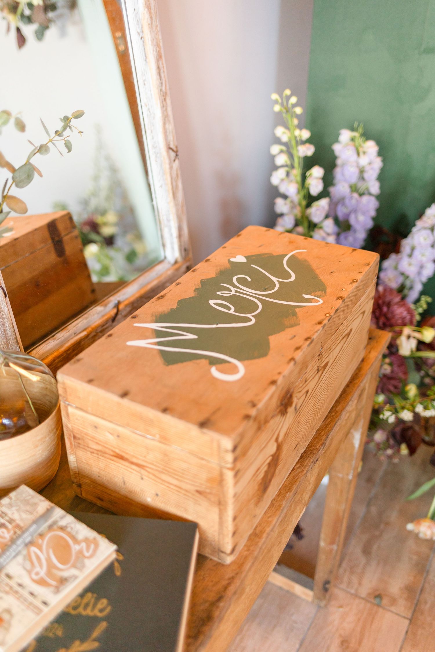 Wooden decorative boxes with handwritten text displayed at wedding reception.