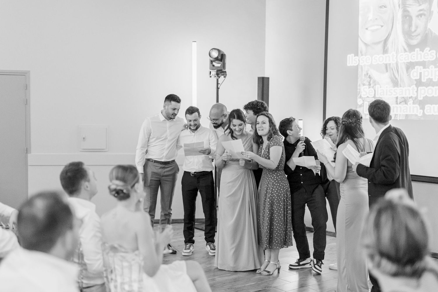 Wedding guests dance and celebrate together in a festively decorated reception venue.
