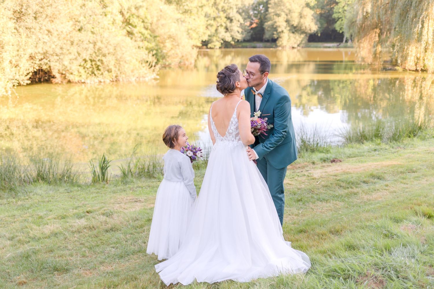Wedding ceremony by a lake with beautiful golden sunlight.