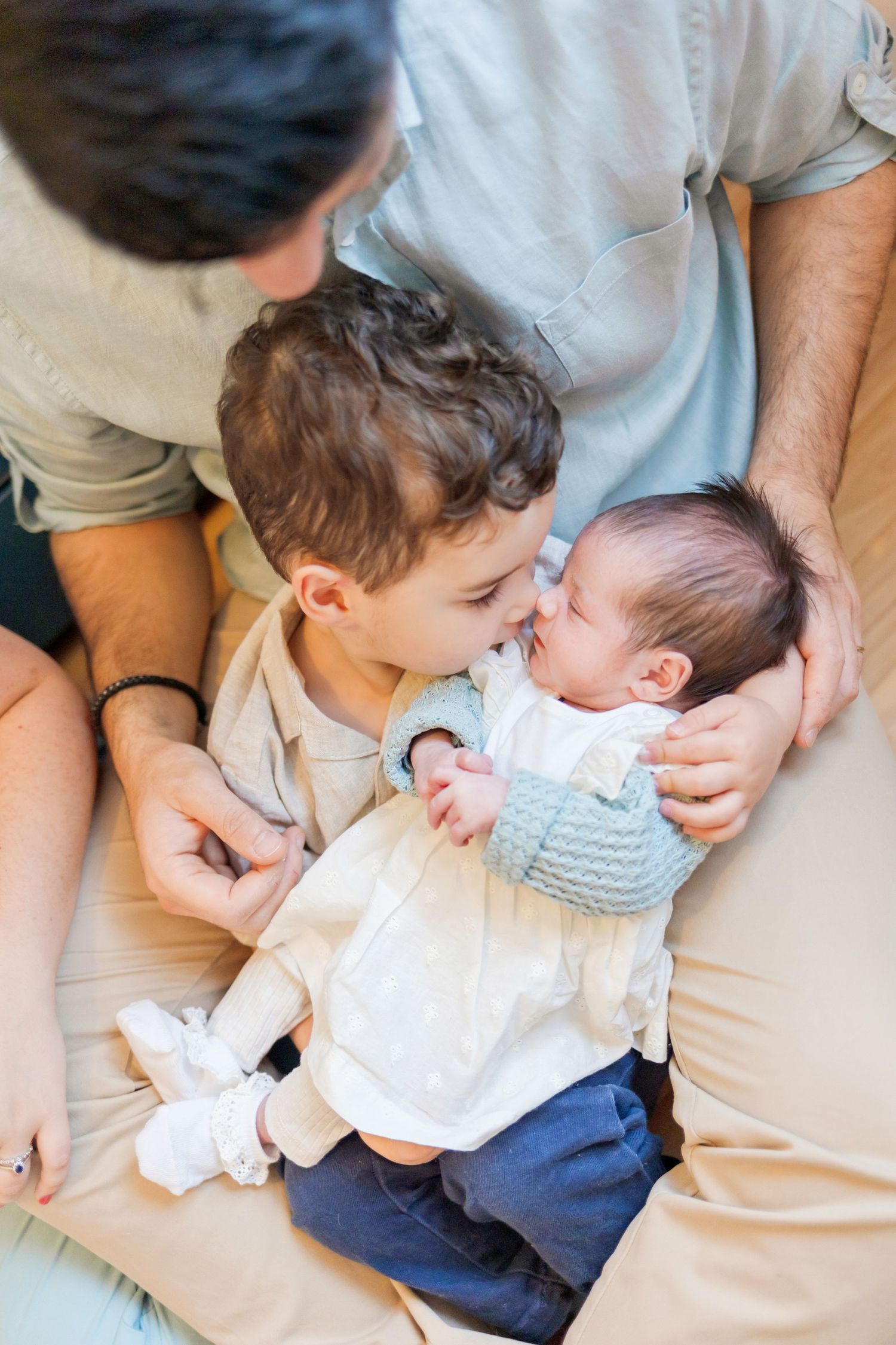 A color photo capturing a heartwarming moment between siblings as they share a gentle embrace.