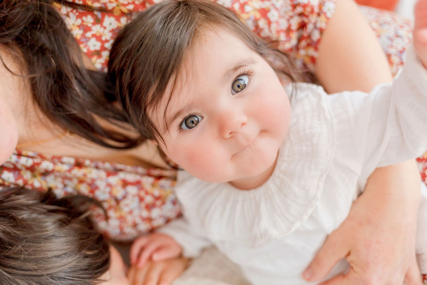 Intimate lifestyle photography with soft natural lighting and floral patterns.