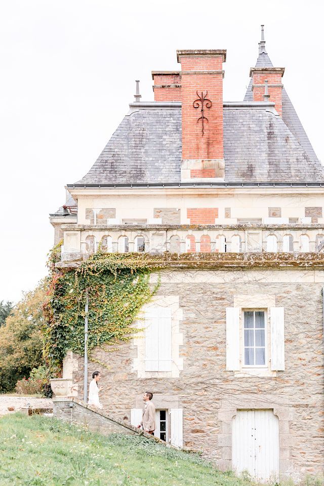 Classic French architecture featuring stone walls and terracotta chimneys on historic chateau.