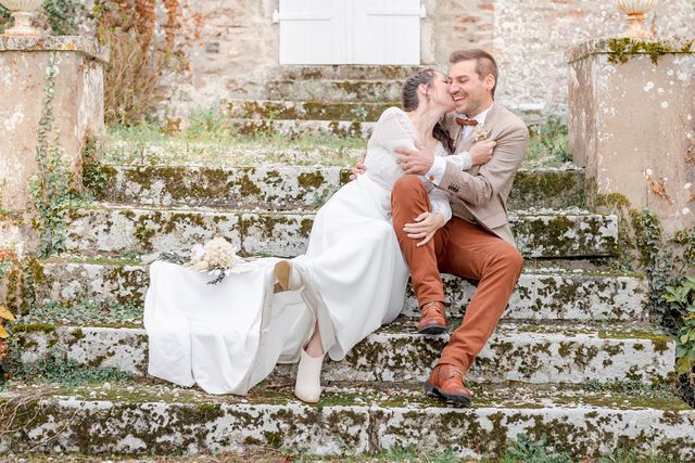 Wedding couple sitting on ancient stone steps with vintage charm and natural lighting.